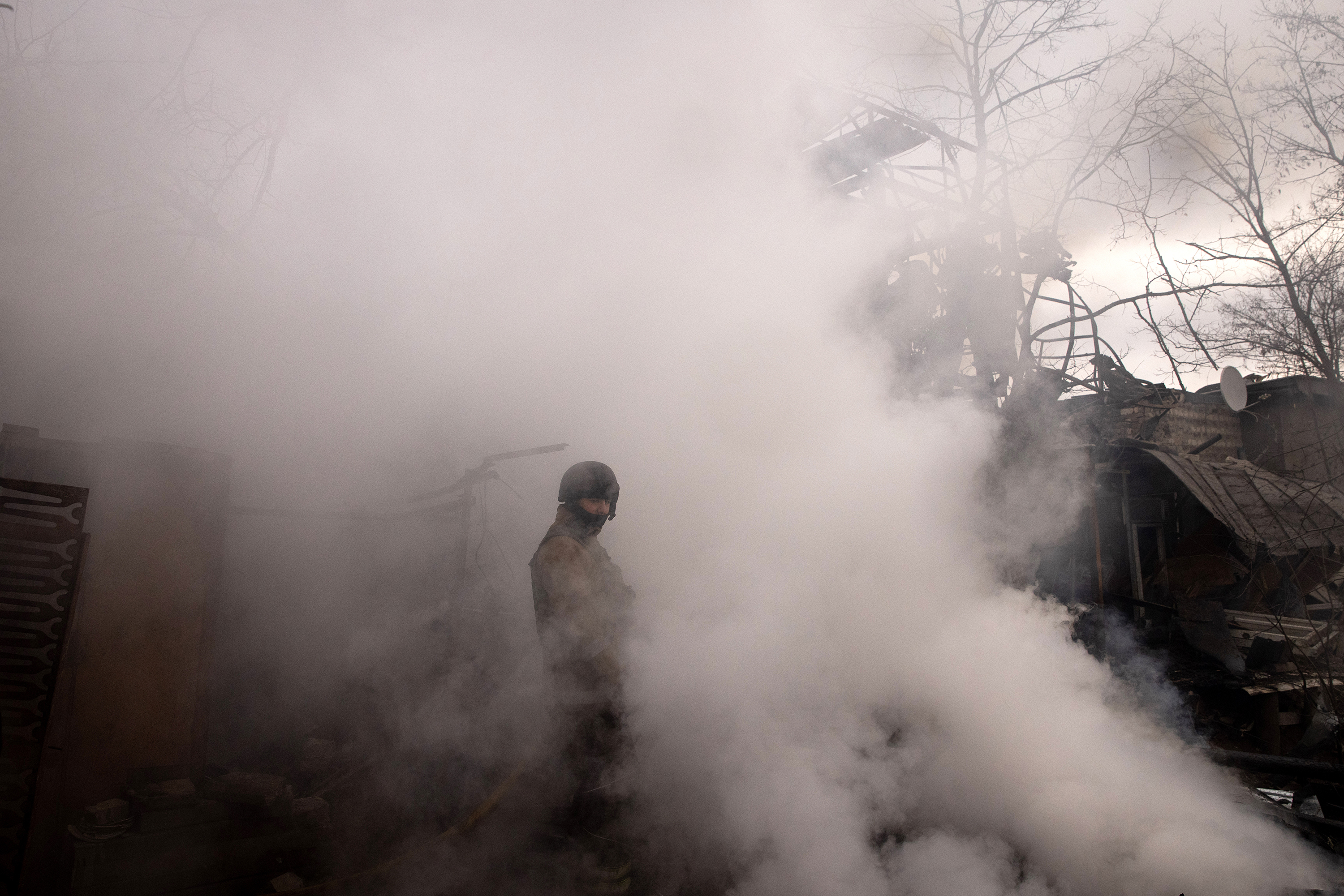 April 14: A firefighter works to extinguish a fire at a warehouse caused by recent Russian shelling in Kharkiv, Ukraine. After Russian forces retreated from areas around Kyiv, recent reports point to a new offensive as Russian forces have regrouped in the eastern part of the country bringing fears of an escalation of violence.