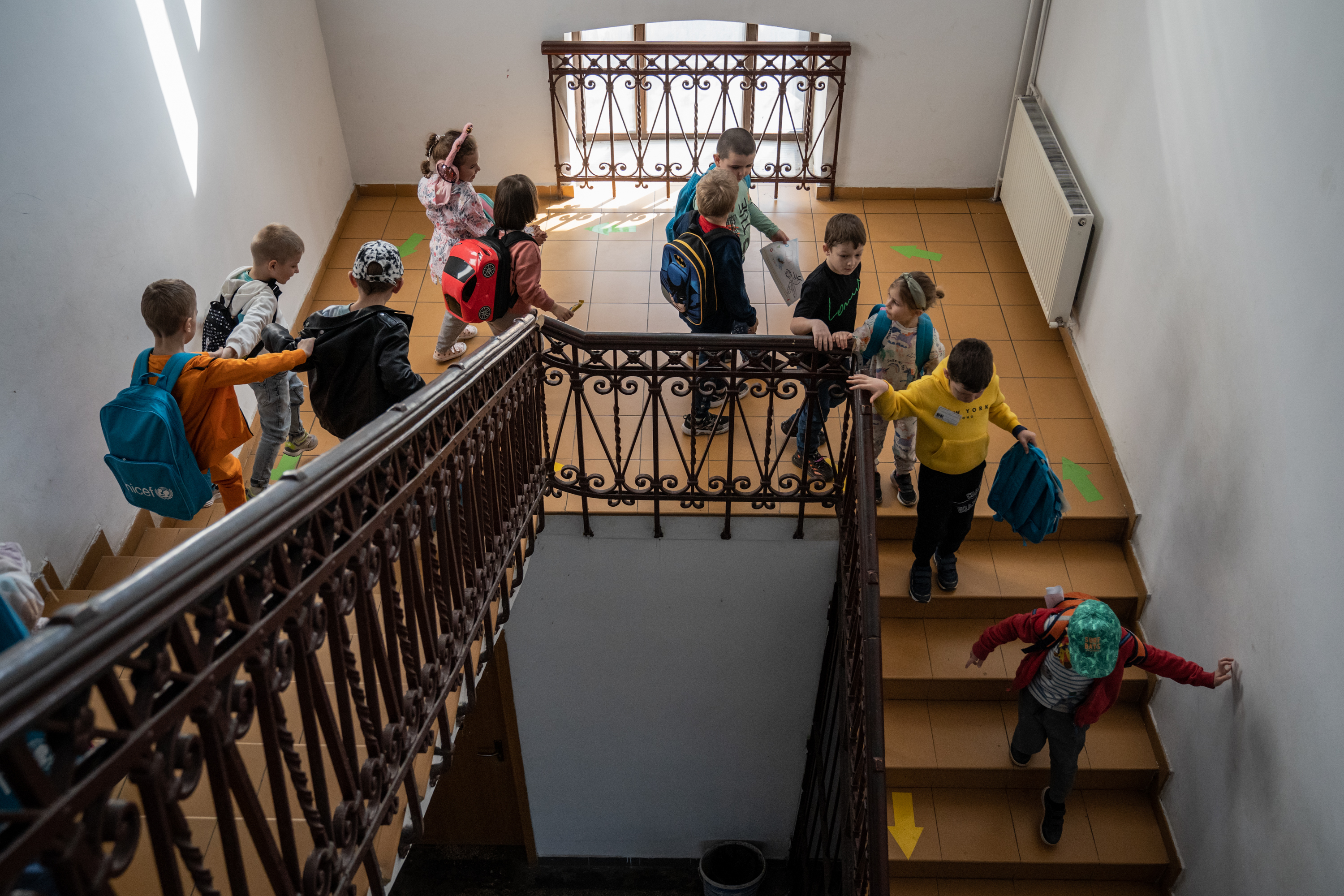 A teacher set up a school for Ukrainian refugee children in Romania 4 Ukrainian children run downstairs to leave the school after classes.