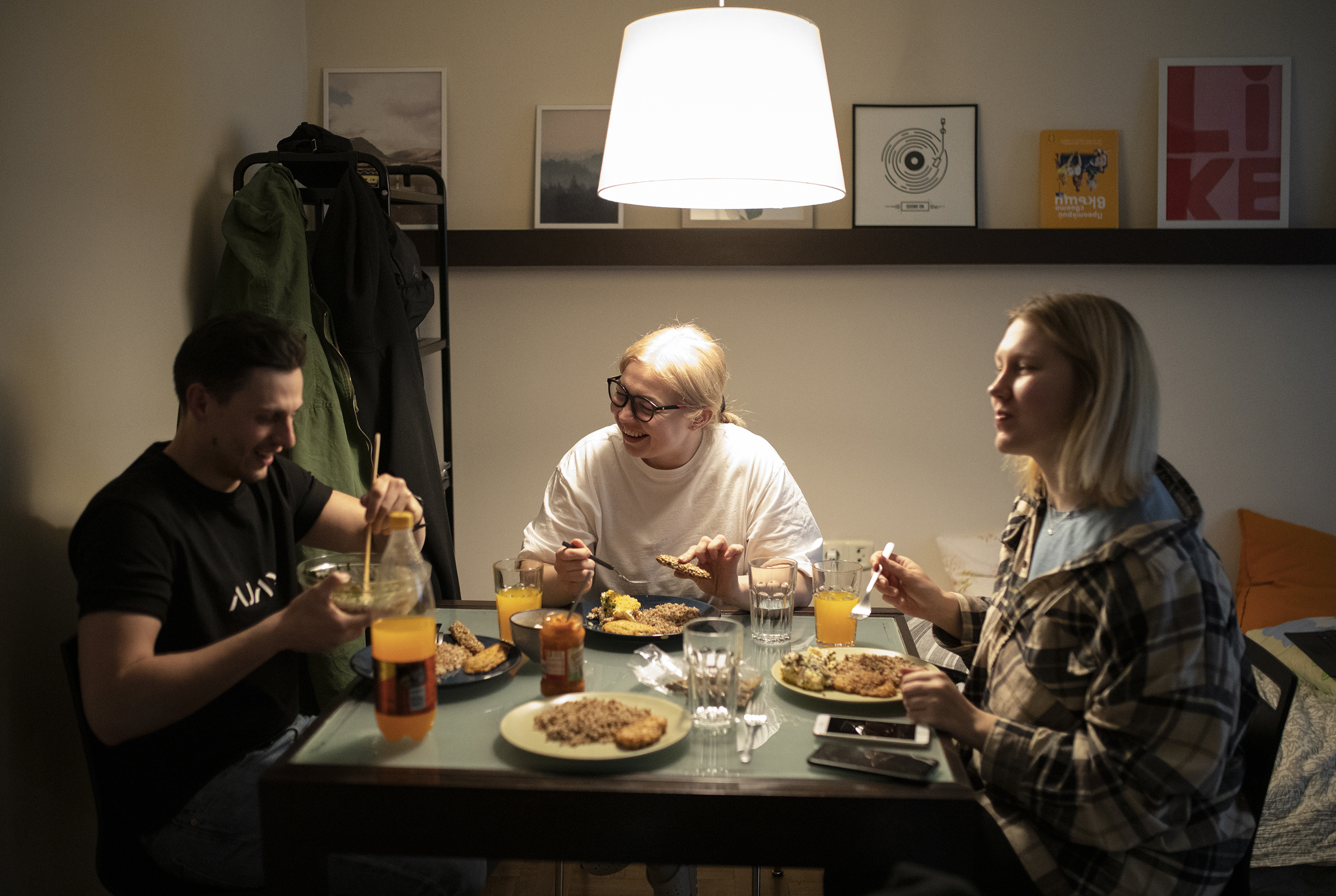 Josif Feny, left, Anet Pchelnikova, right, Natasha Nykolyn, center, have dinner at their apartment in in Sofia, Bulgaria, on Friday, April 22. (Spasiyana Sergieva for NPR)