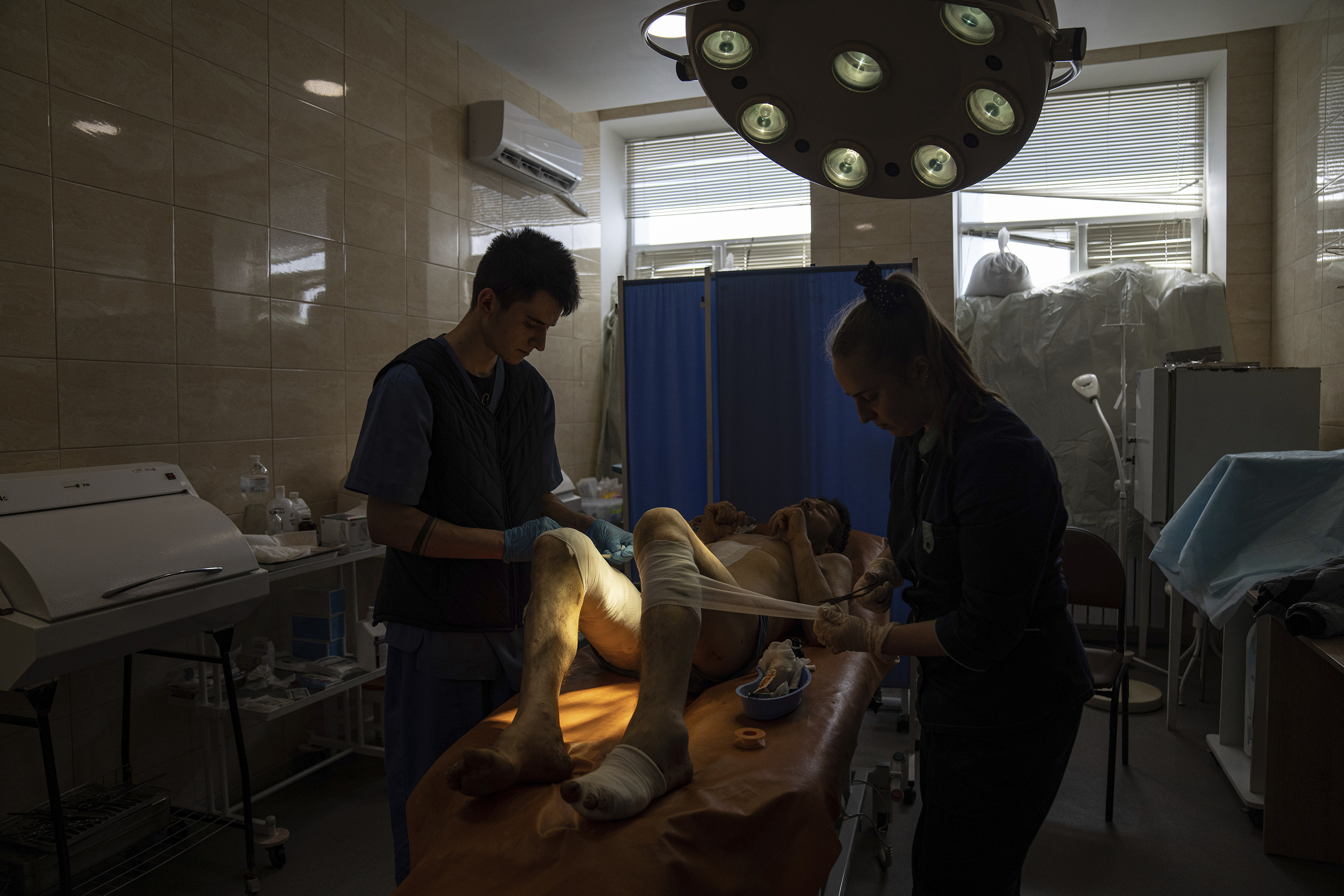 April 26: Medical workers treat Volodymyr Nikiforov, 40, injured by shelling near Barvenkove at a hospital in Kramatorsk, in eastern Ukraine.