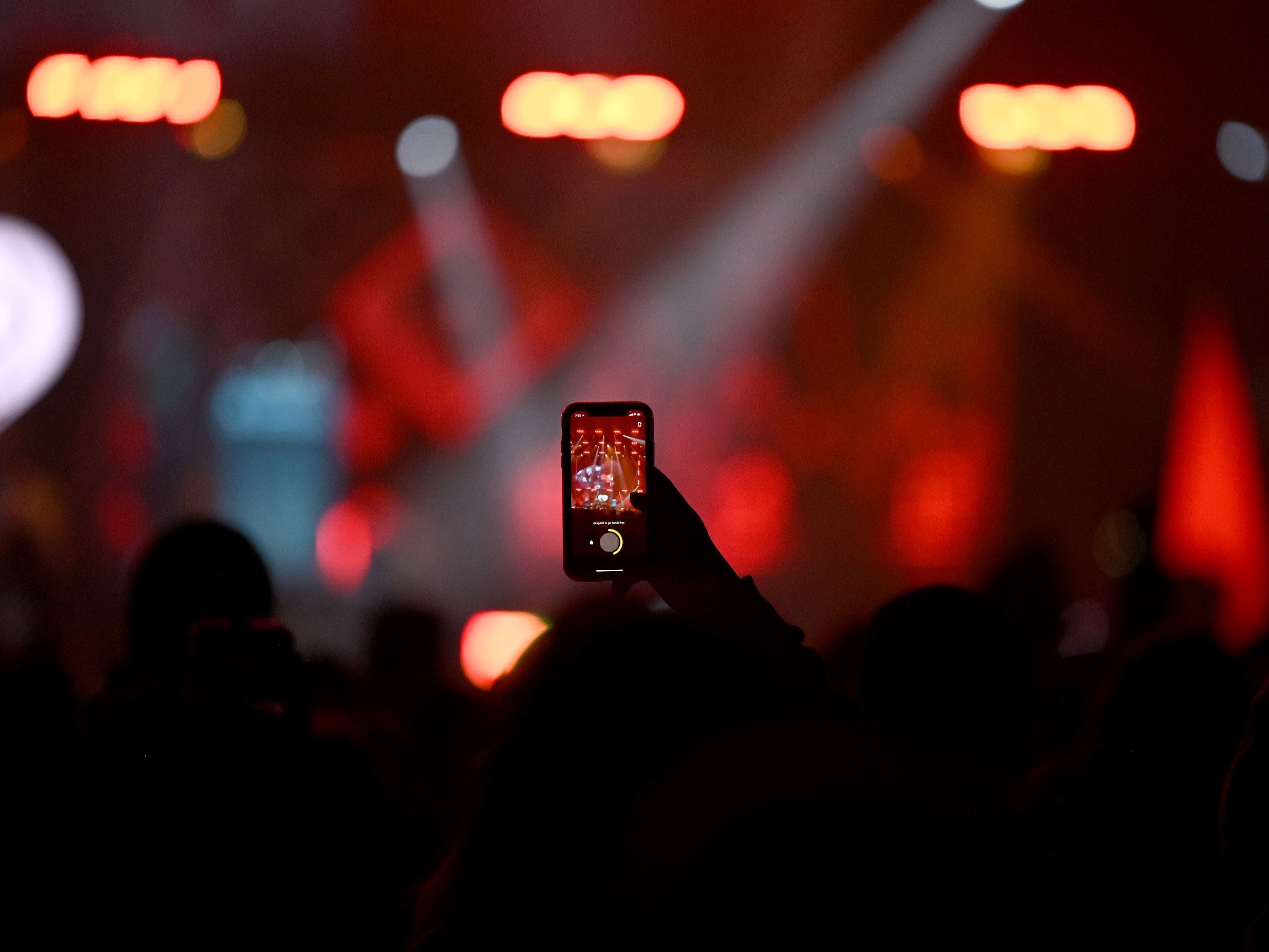 St. Paul, Minnesota - December 6, 2021: A fan uses his phone to record the concert during iHeartRadio 101.3 KDWB's Jingle Ball 2021 event presented by Capital One at Xcel Energy Center in St. Paul/Minneapolis, Minnesota. (Photo by Stephen Maturen/Getty Images for iHeartRadio)