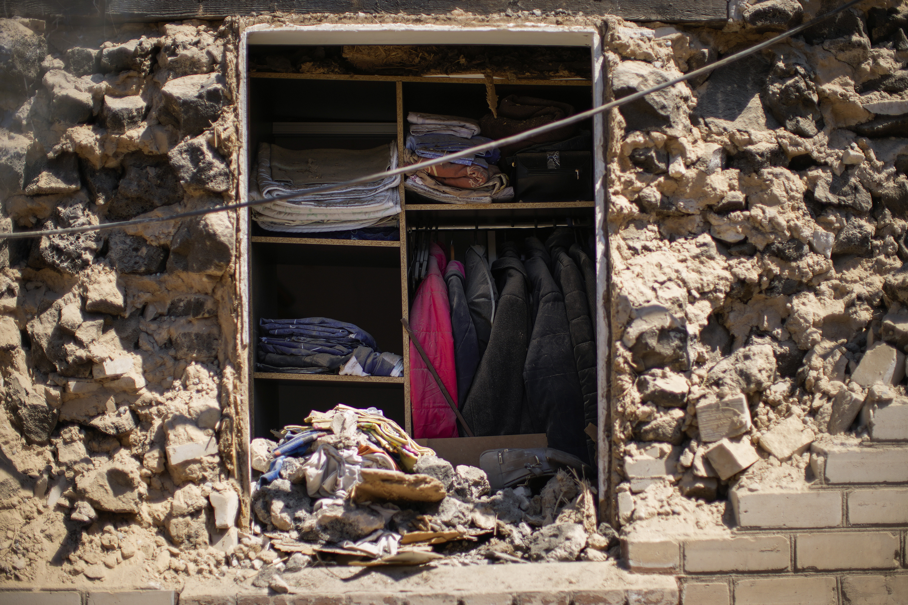 April 28: Clothes hung in a closet of a destroyed house after a Russian rocket, hit by Ukraine's anti-aircraft system, stroke in a residencial area in Zaporizhzhia, Ukraine