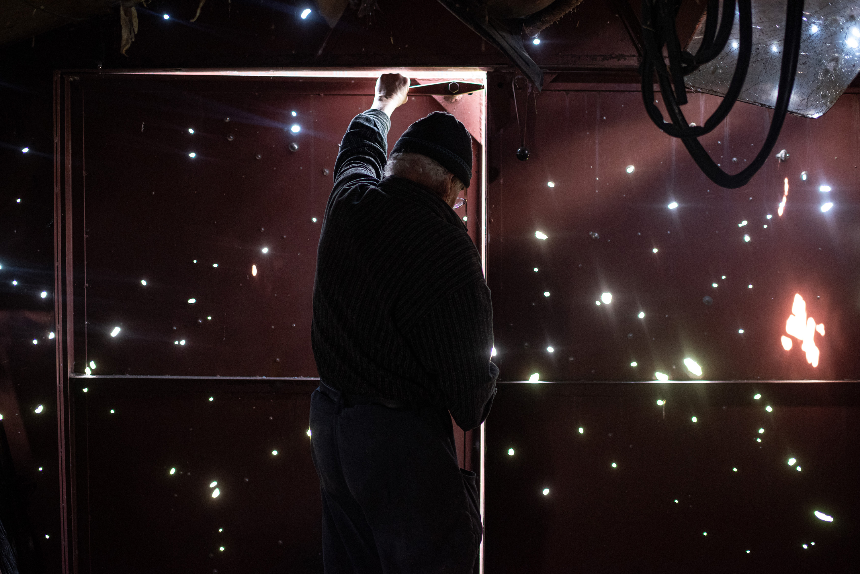 April 28: Volodymyr Tykhonov, 76, opens the door of his garage that has numerous bullet holes, in Zahaltsi, Ukraine.