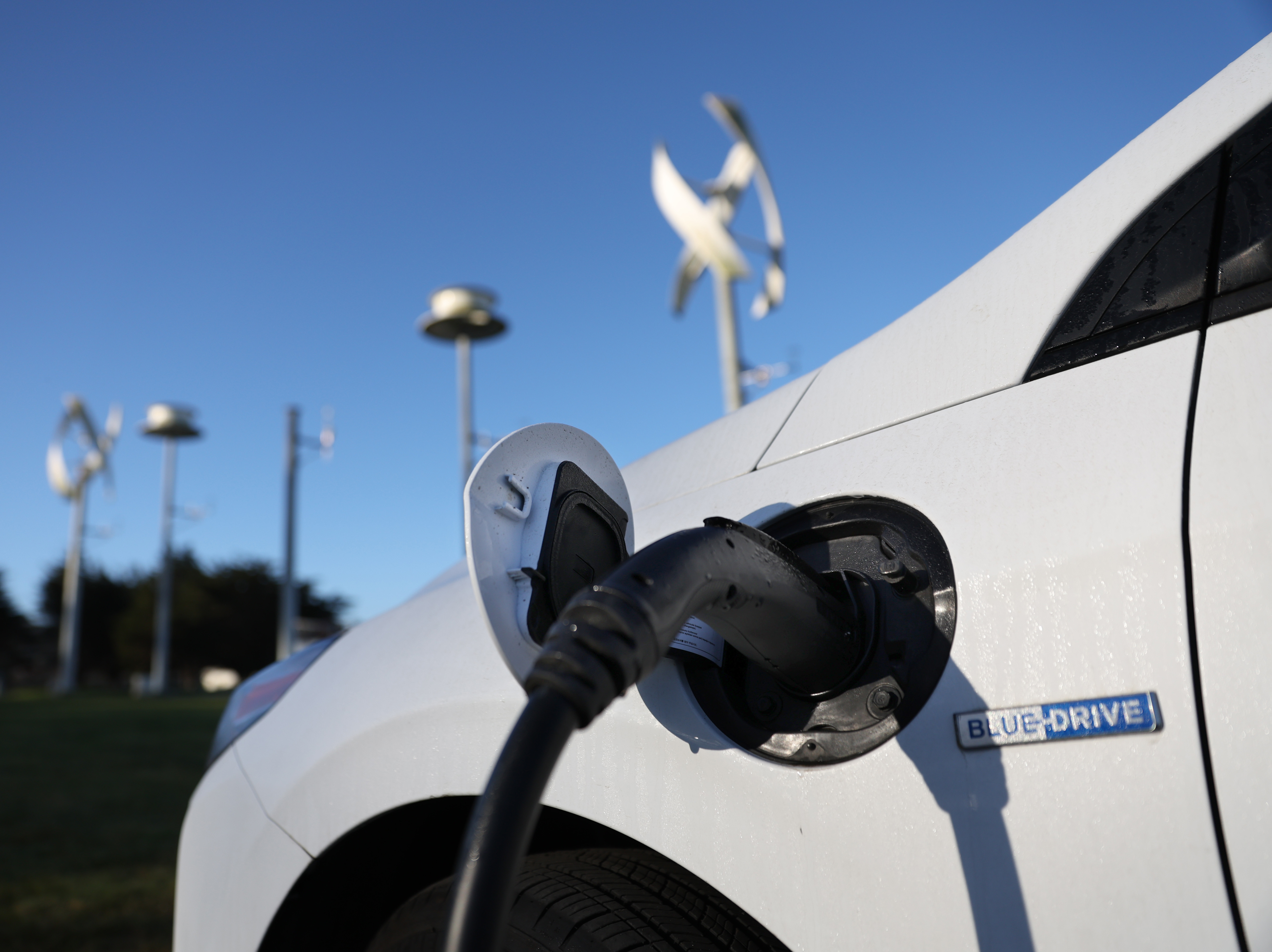 An electric vehicle gets its battery recharged at a charge station in San Francisco on March 9. The Biden administration is spending $5 billion to build a network of chargers in a bid to get more people to buy electric cars. (Getty Images)