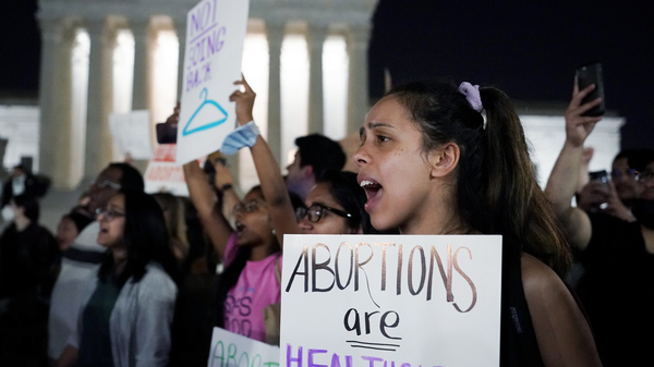 A crowd of people gather outside the U.S. Supreme Court early on Tuesday after a draft opinion was leaked indicating the court could strike down Roe v. Wade.