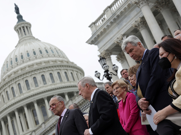 Senate Majority Leader Chuck Schumer, D-N.Y. (left), and Senate Majority Whip Dick Durbin, D-Ill. (next to Schumer), listen during an event on Tuesday about the leaked Supreme Court draft decision to overturn Roe v. Wade.