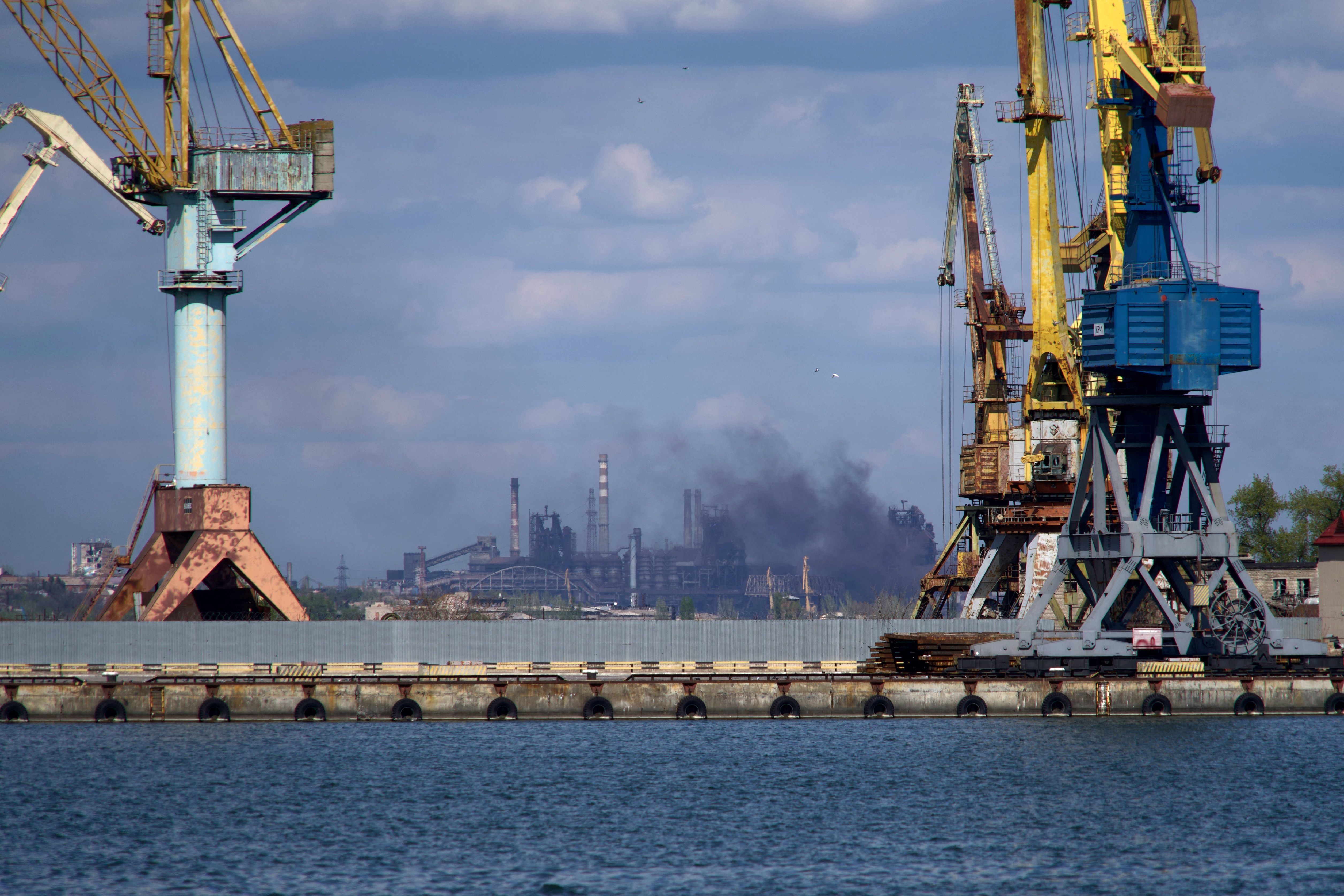Smoke rises above the Azovstal steel plant in Mariupol on April 29, amid Russia's invasion of Ukraine. Hundreds of civilians are still trapped inside, officials say. (AFP via Getty Images)