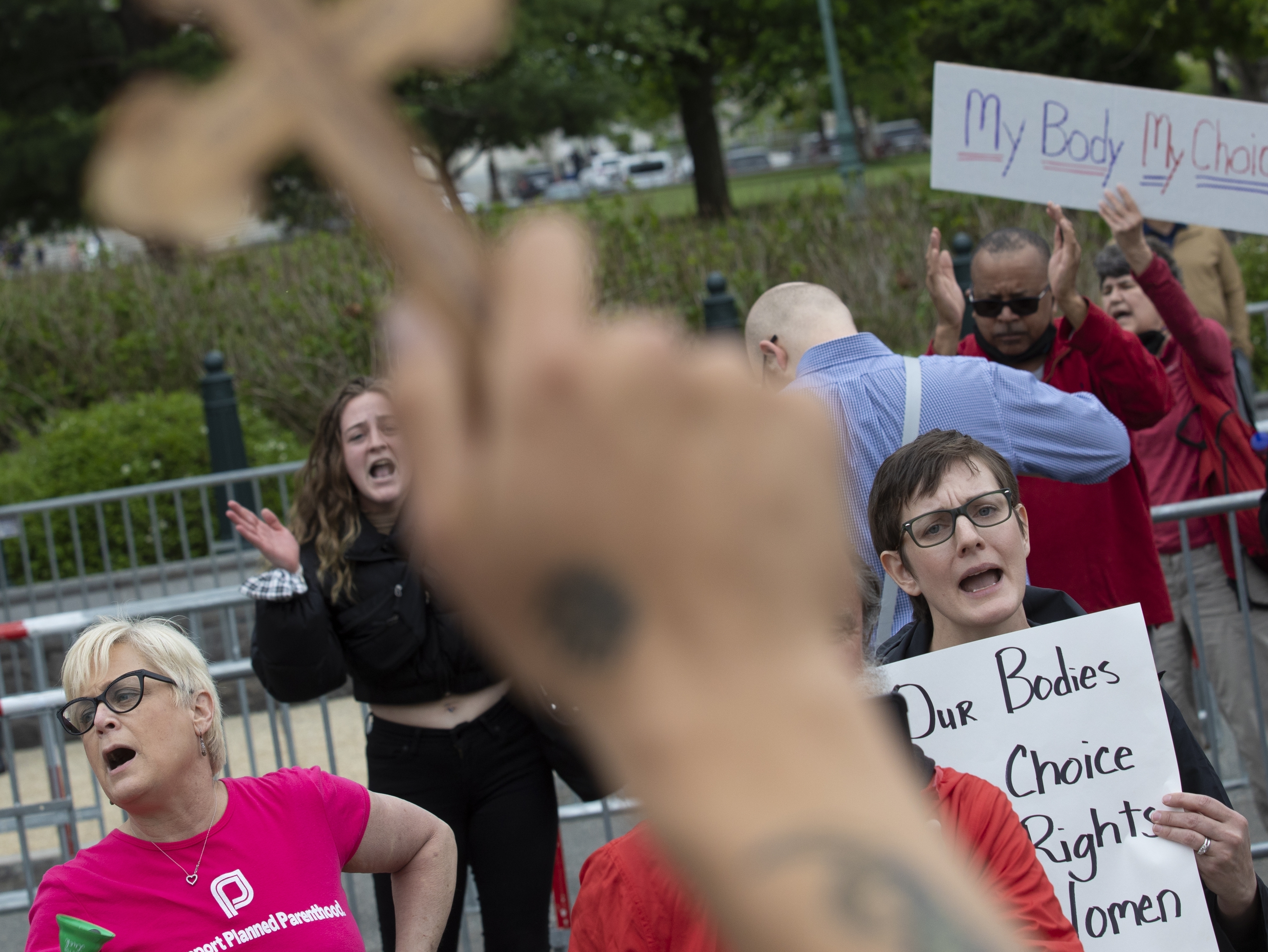 Nate Darnell holds a cross while surrounded by chanting abortion-rights demonstrators outside the U.S. Supreme Court on Thursday in Washington, D.C. (Getty Images)