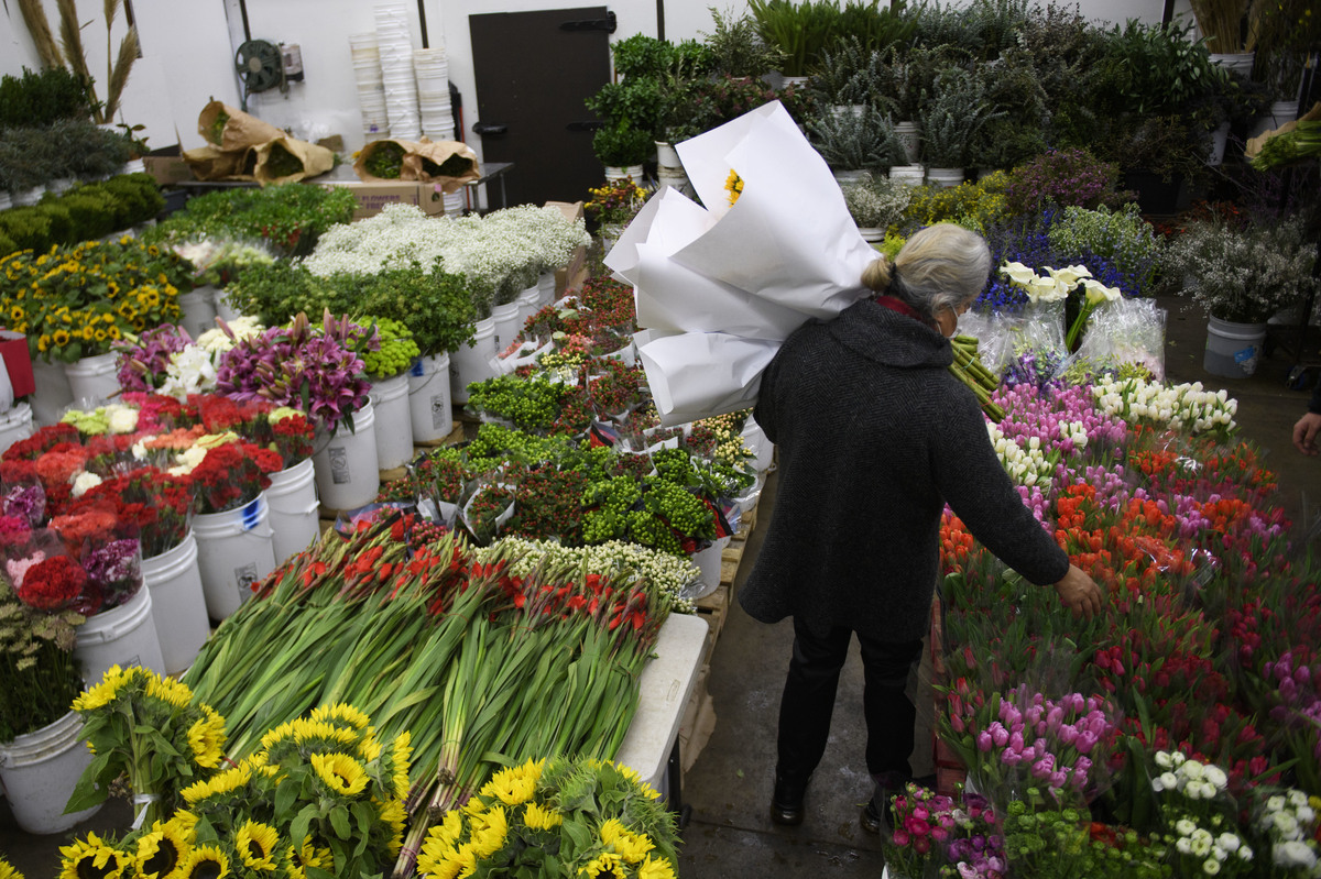 A buyer shops for flowers at the Southern California Flower Market on Feb. 12, 2021, in Los Angeles.