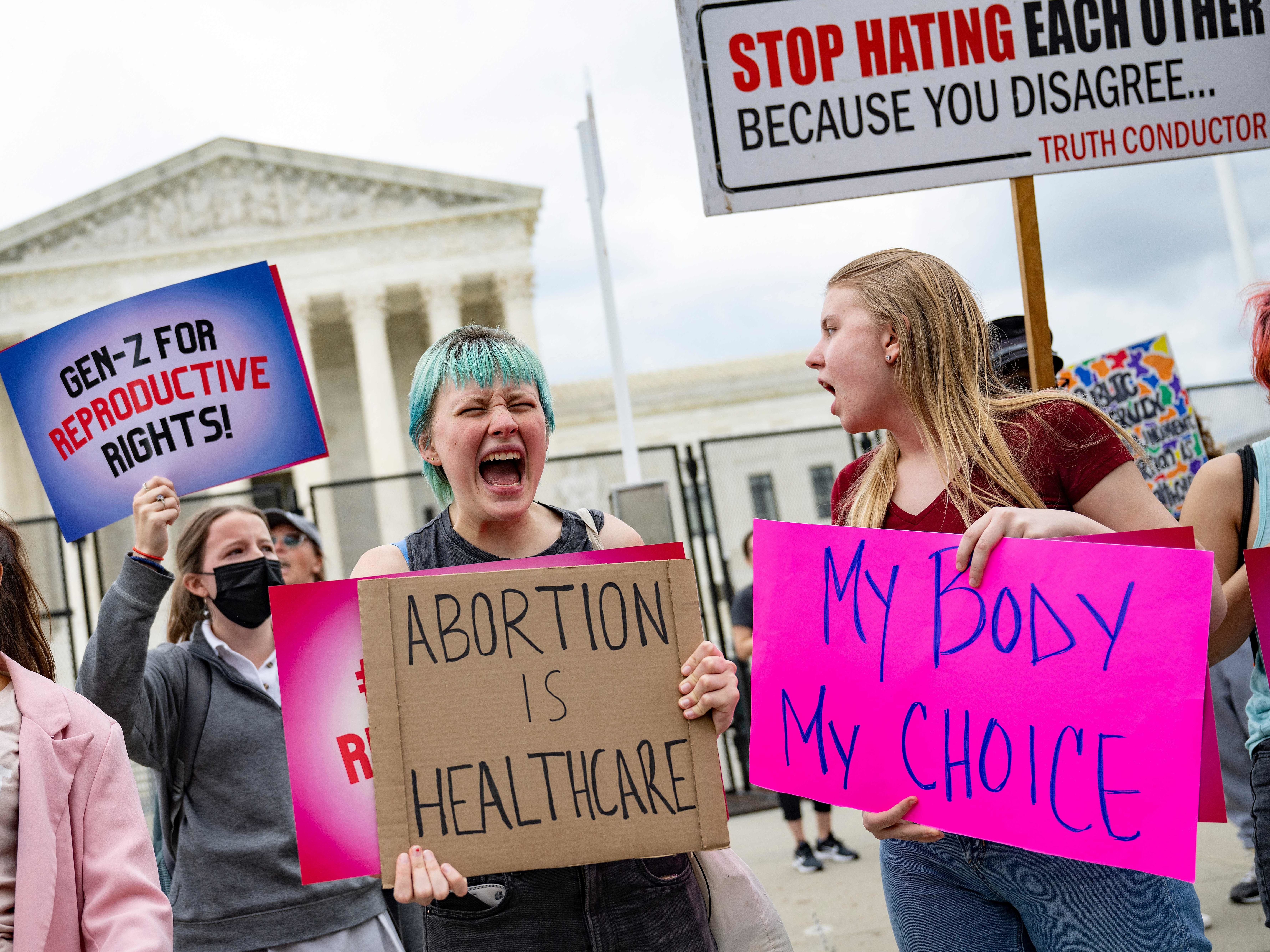 Young people who support access to abortion chant in front of un-scalable fence that stands around the US Supreme Court in Washington, DC, on May 5, 2022. (AFP via Getty Images)