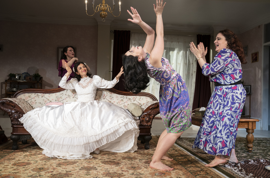 Marjan Neshat (in white dress), Roxanna Hope Radja (behind couch), Nikki Massoud and Artemis Pebdani in Wish You Were Here.