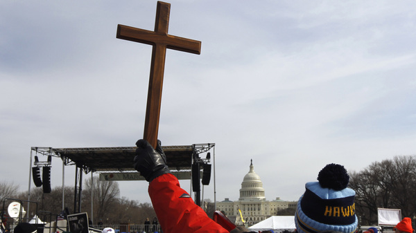 A man holds a cross during an anti-abortion rally on the National Mall in Washington on Jan. 24, 2011.