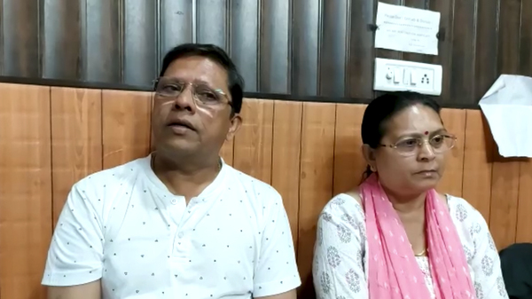 This image from video shows Sanjeev Ranjan Prasad, a 61-year-old retired government officer, and his wife Sadhana Prasad as they wait at a lawyer