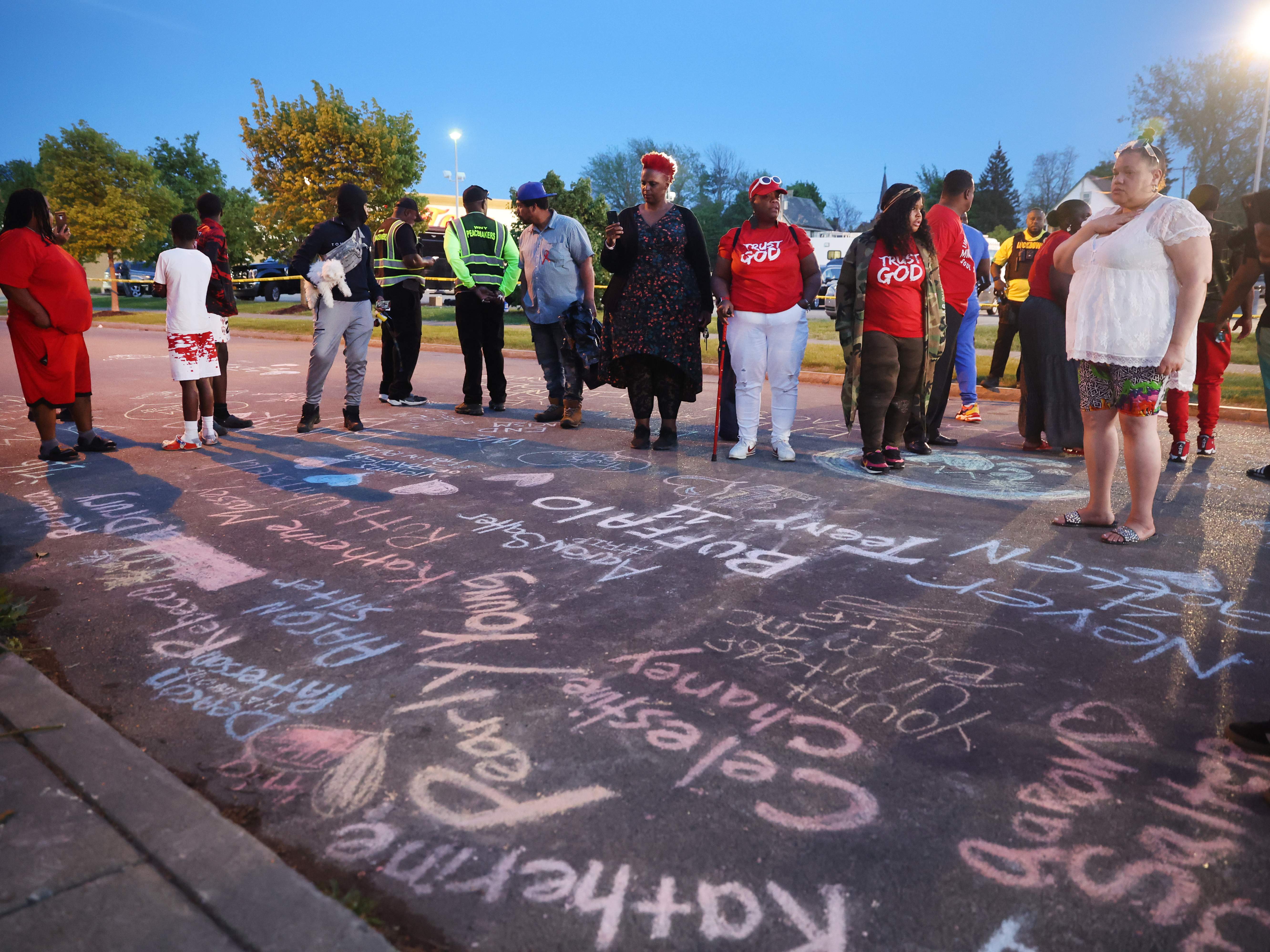 The names of the victims and messages of healing written in chalk at a makeshift memorial outside of the Tops supermarket in Buffalo, N.Y., on Sunday, one day after a gunman killed 10 people and injured 3 others. (Getty Images)