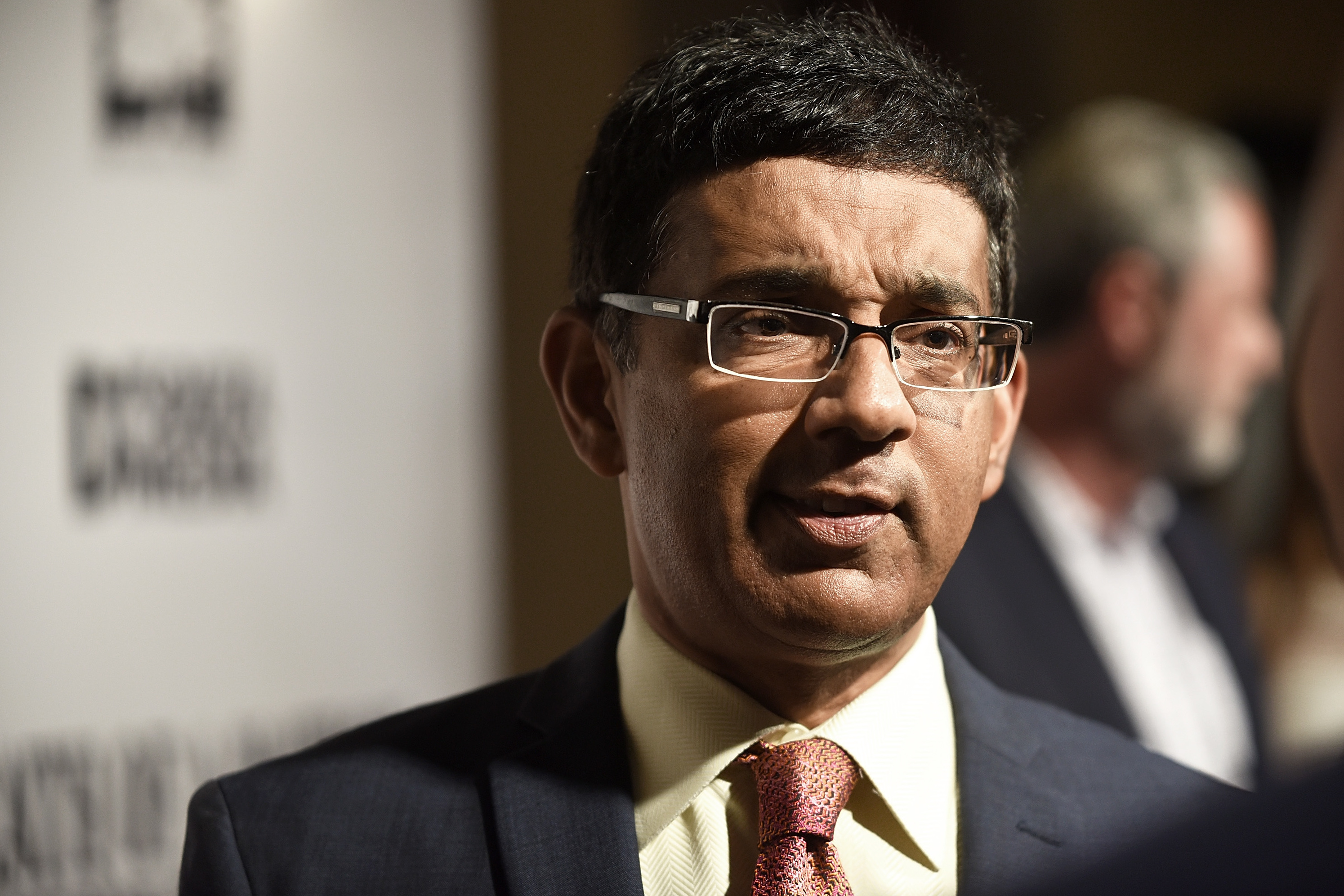 Dinesh D'Souza, seen here at a premiere of one of his films in 2018, has released a new film alleging voter fraud in the 2020 presidential election. Fact checkers have cast doubt on many of the film's claims. (Getty Images)