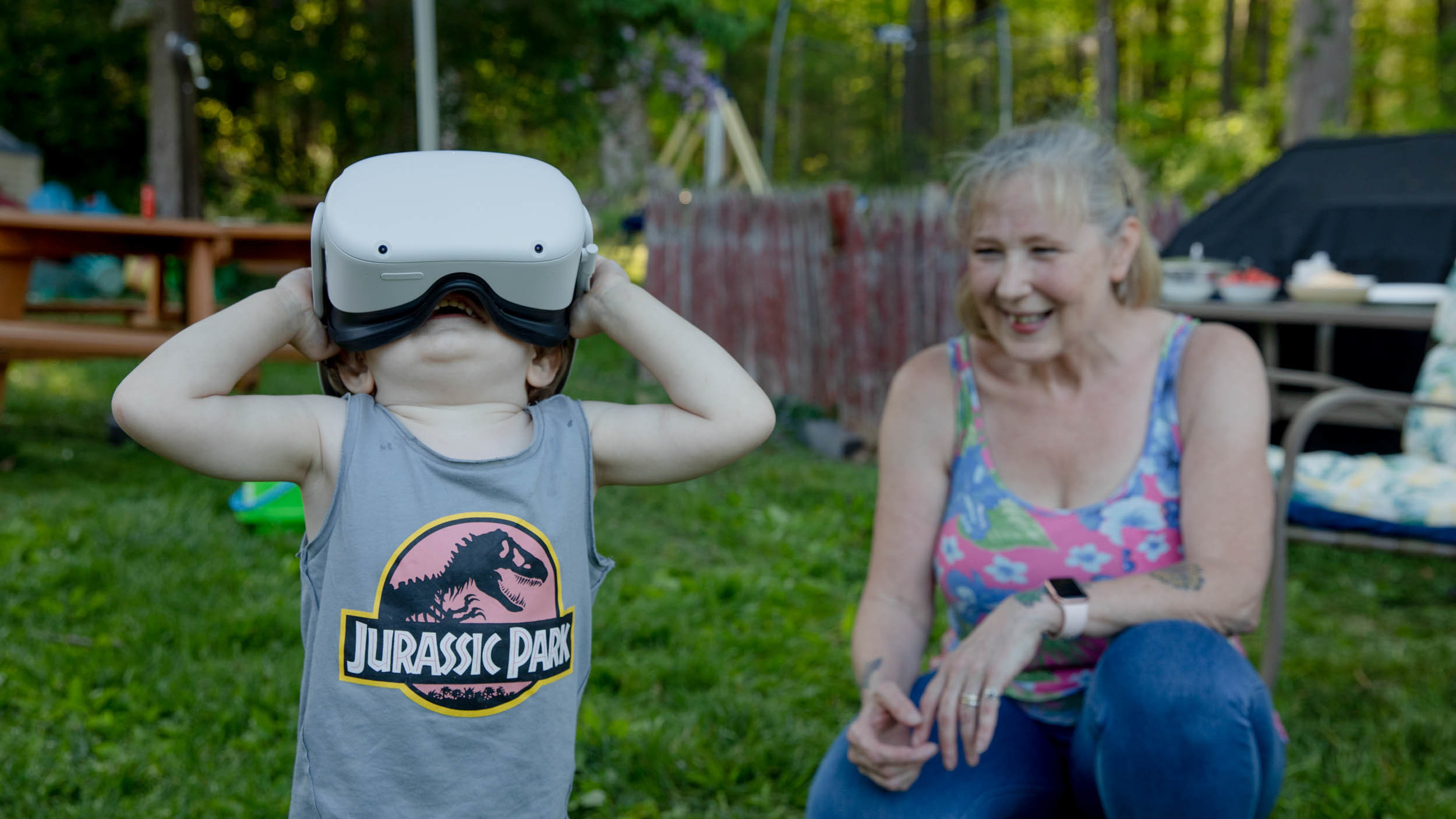 Linda Munson's youngest grandson, Daniel Gomez, 2, tries on an Oculus headset in her yard in Berlin, Conn. Playing different virtual reality games has become her family's regular Sunday activity, Munson said.