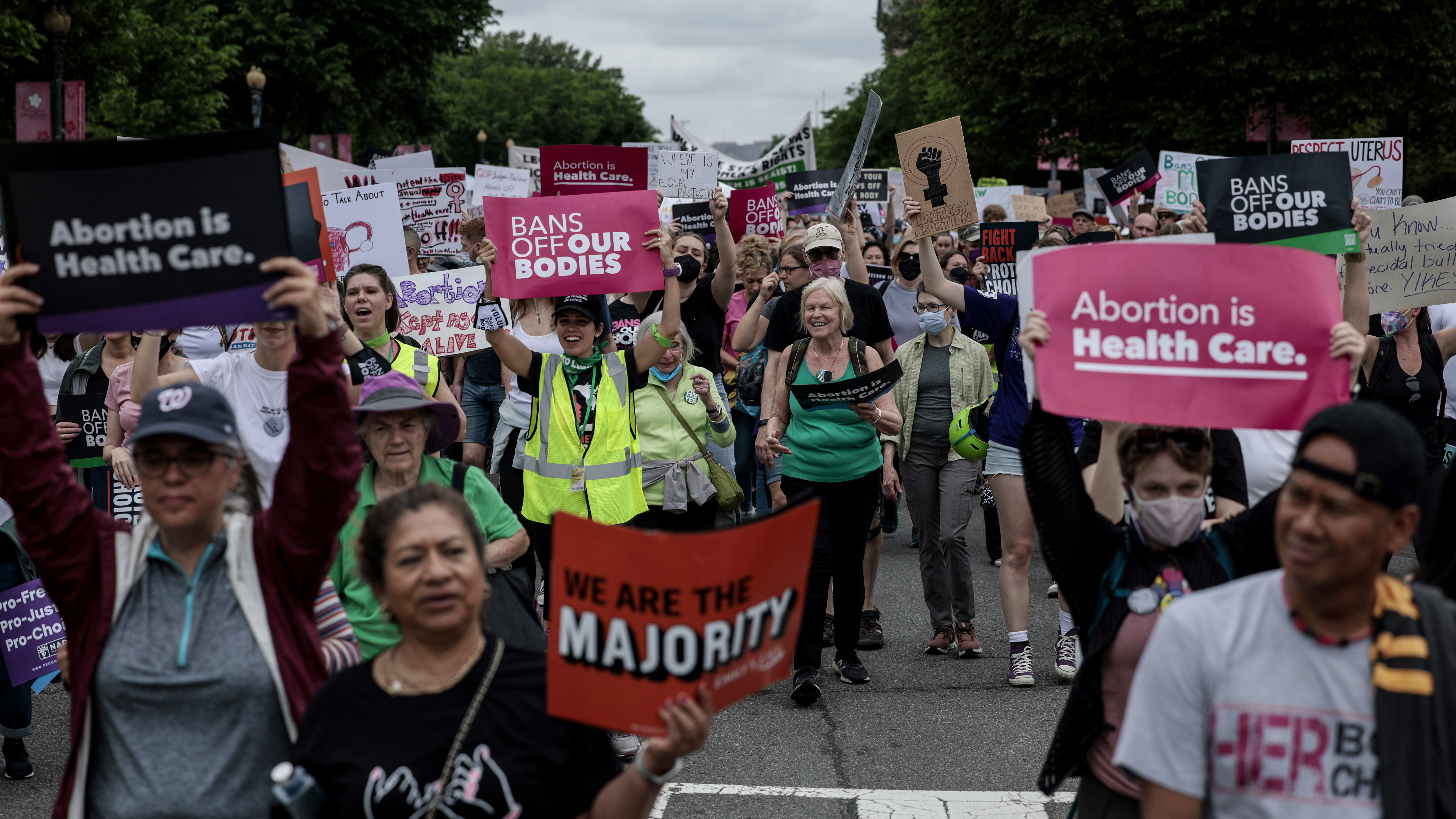Pro-abortion rights demonstrators march in Washington, D.C., on May 14. While most U.S. adults favor some restrictions on abortion, according to our new poll, most also say they do not support overturning <em>Roe v. Wade</em>. (Getty Images)