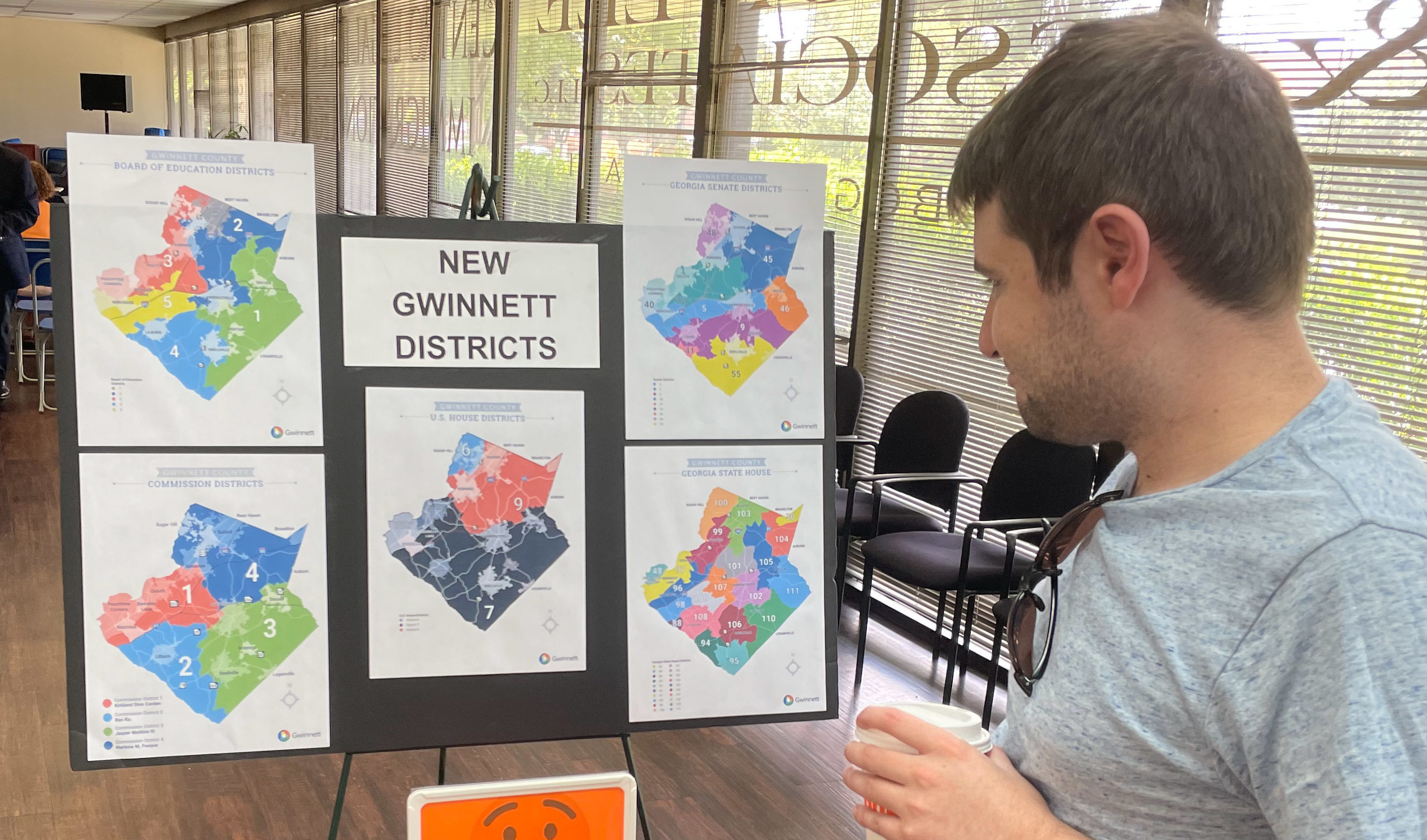 A man looks at newly drawn congressional districts for Gwinnett County, Ga., at a meeting of county Democrats this month. (WABE)