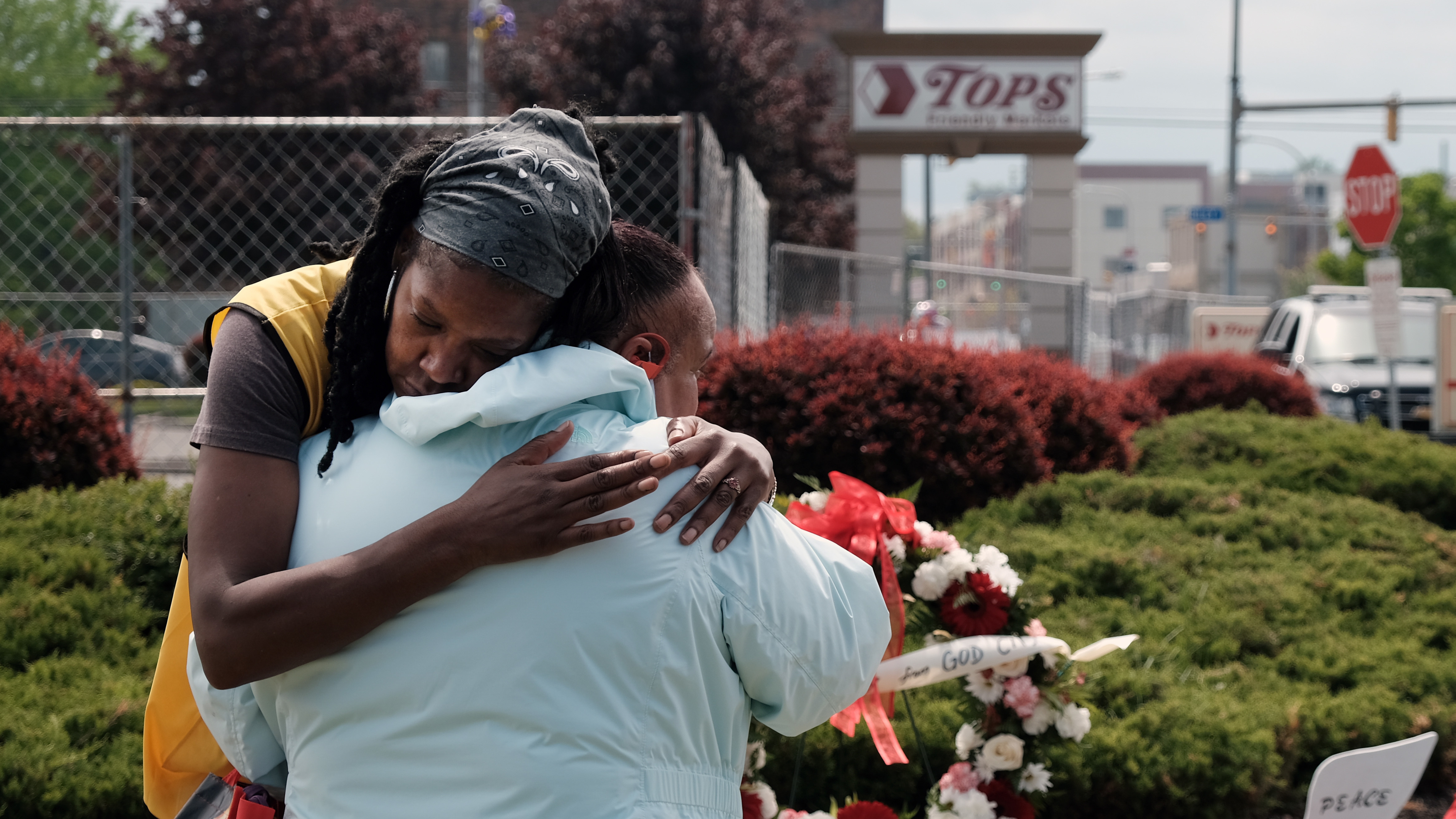 People embrace near a memorial for the shooting victims outside of Tops grocery store on May 20, 2022 in Buffalo, New York.