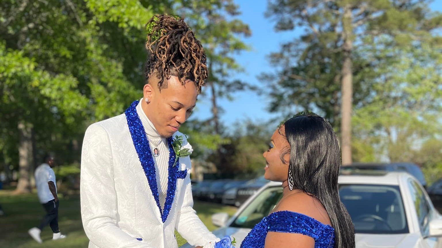 Cameron Frazier and Gabrielle Cistrunk. Cameron wore an embroidered white suit, with blue sequins on the lapel and the bottom of the legs. His shoes featured blue sequin trim.