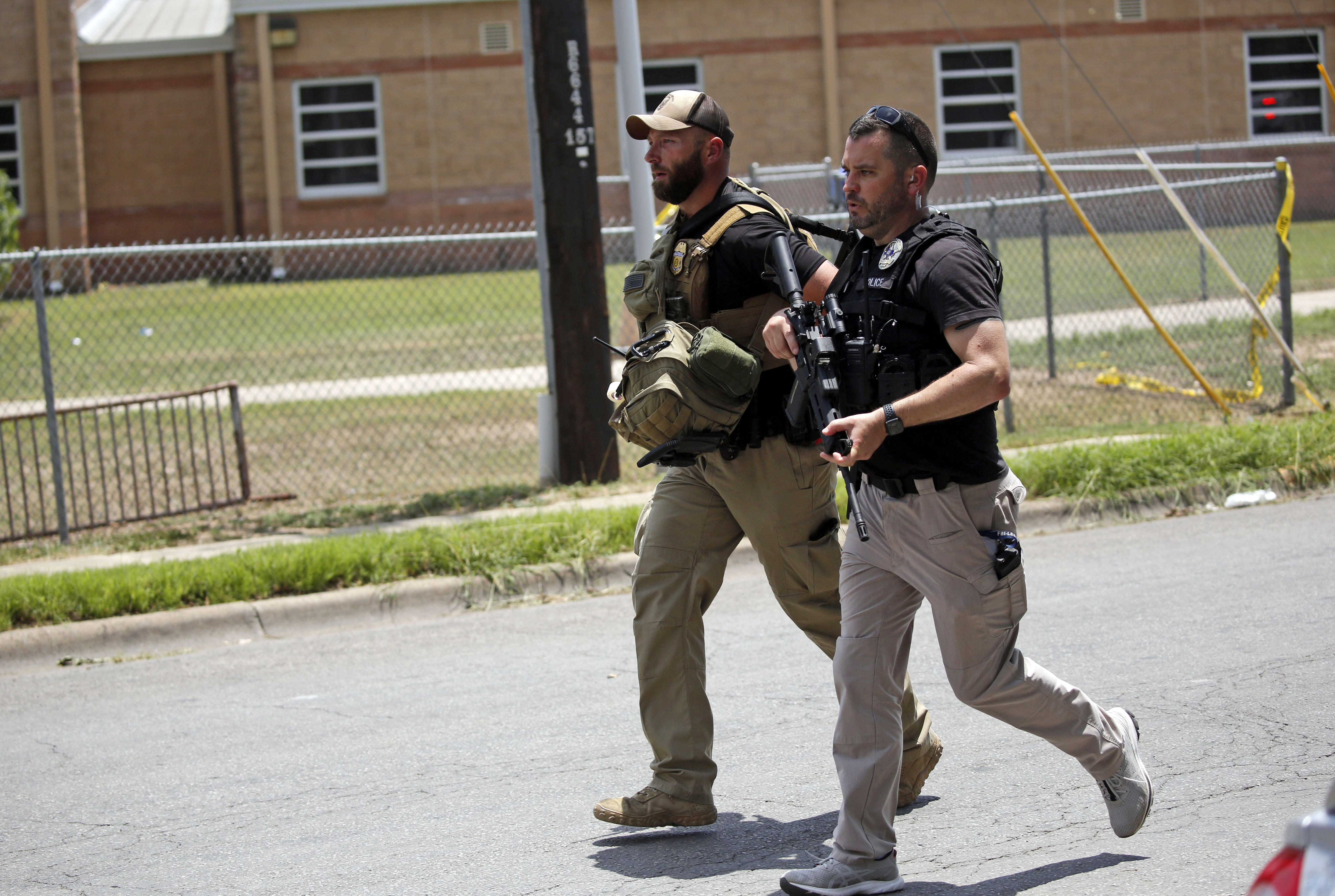 May 24: Police walk near Robb Elementary School following Tuesday's mass shooting.