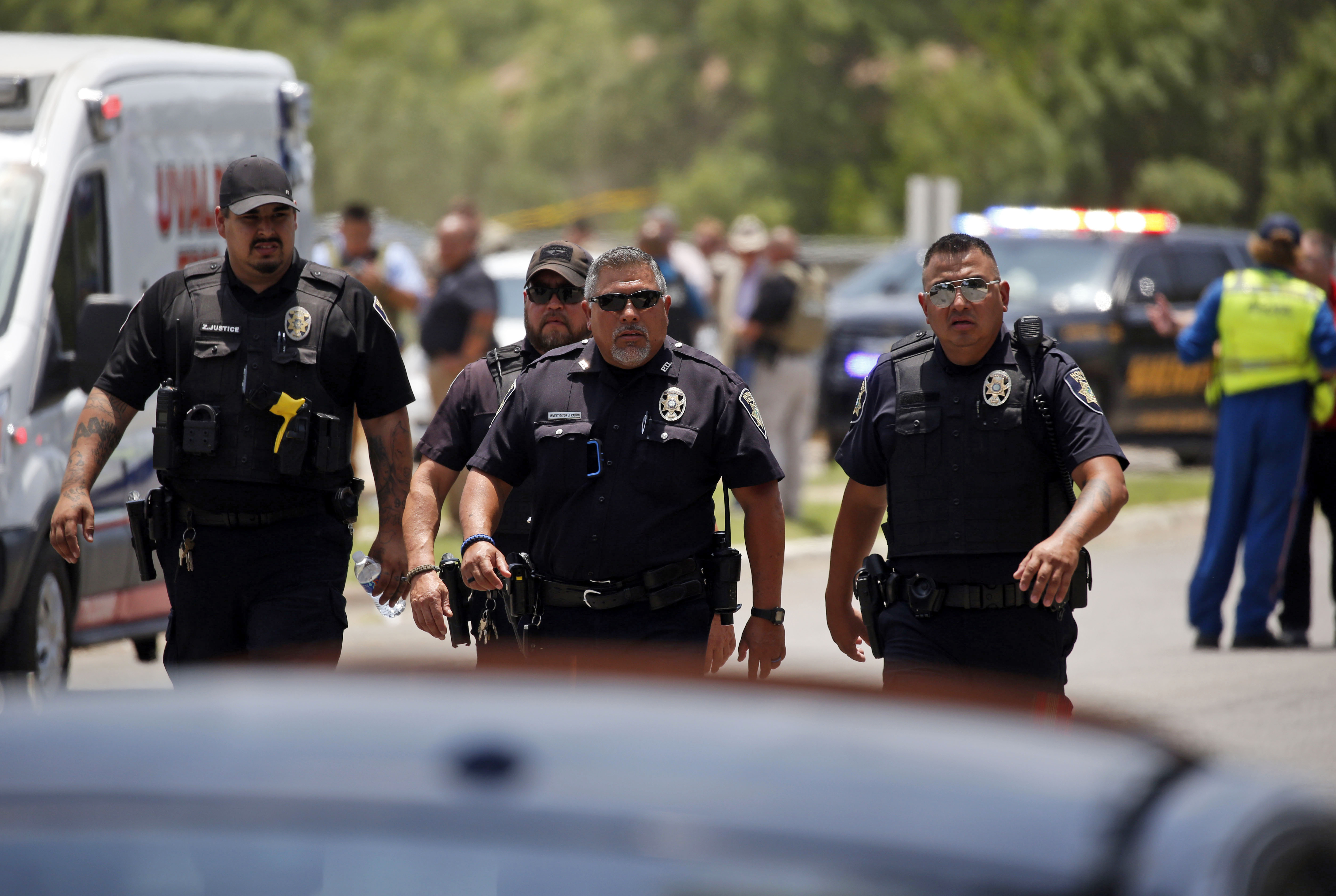 May 24: Police walk near Robb Elementary School following the shooting.