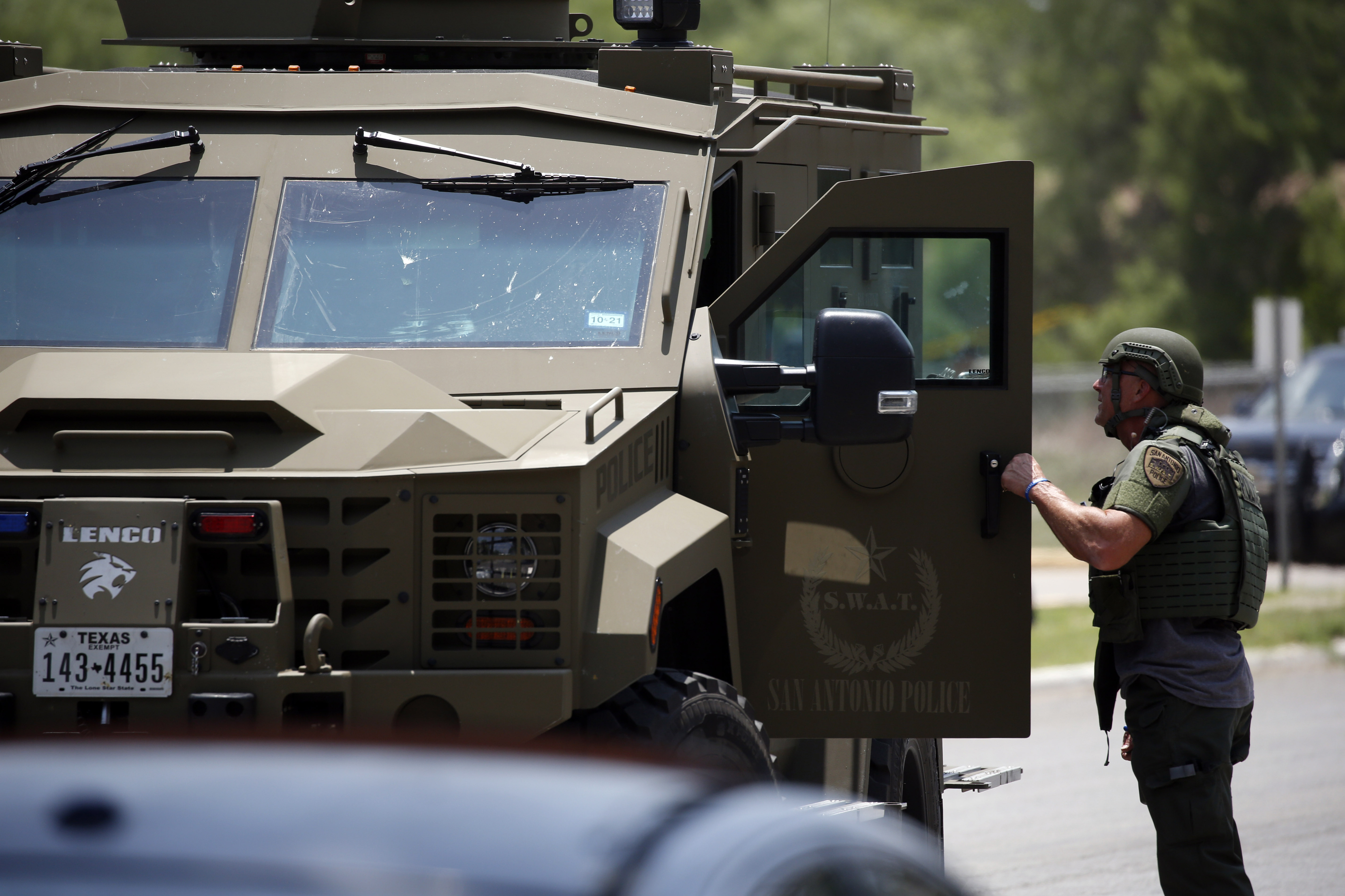 May 24: Law enforcement personnel stand next to an armored vehicle.