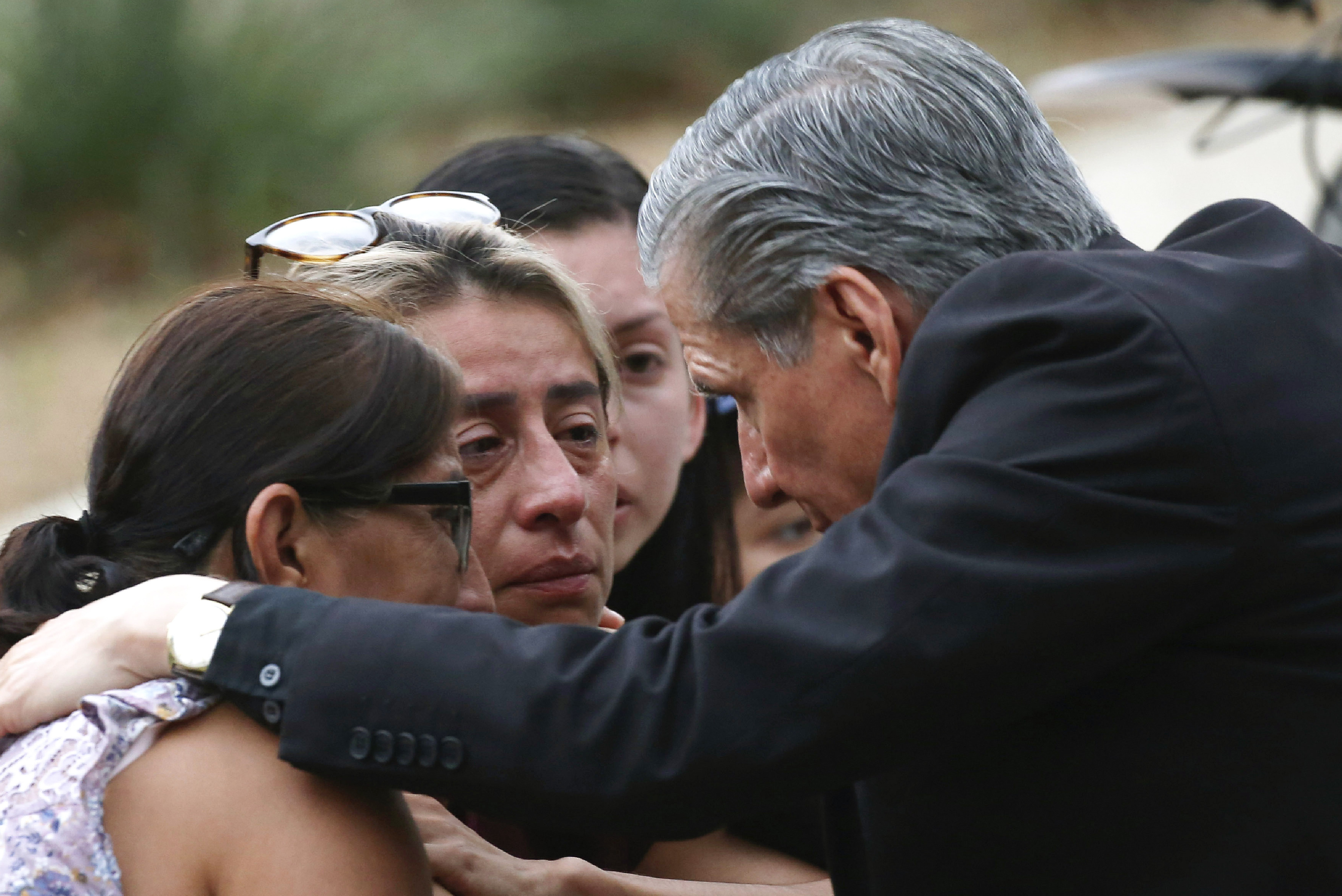 May 24: The Archbishop of San Antonio, Gustavo Garcia Seller, comforts families outside of the Civic Center.