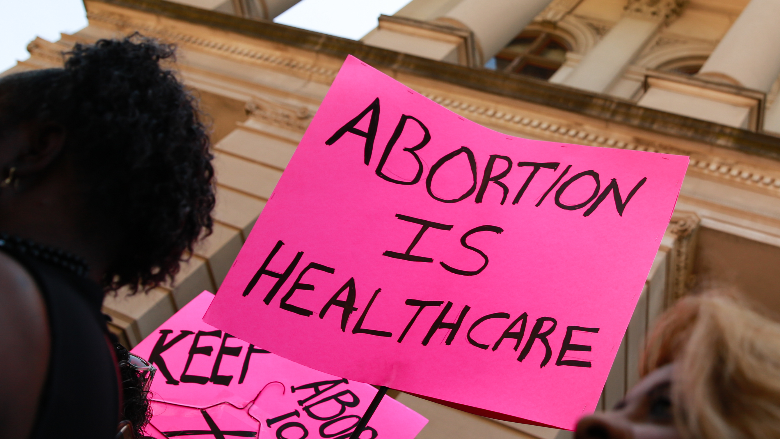 ATLANTA, GA - MAY 21: People hold signs during a protest against recently passed abortion ban bills at the Georgia State Capitol building, on May 21, 2019 in Atlanta, Georgia. The Georgia &quot;heartbeat&quot; bill would ban abortion when a fetal heartbeat is detected. (Photo by Elijah Nouvelage/Getty Images)