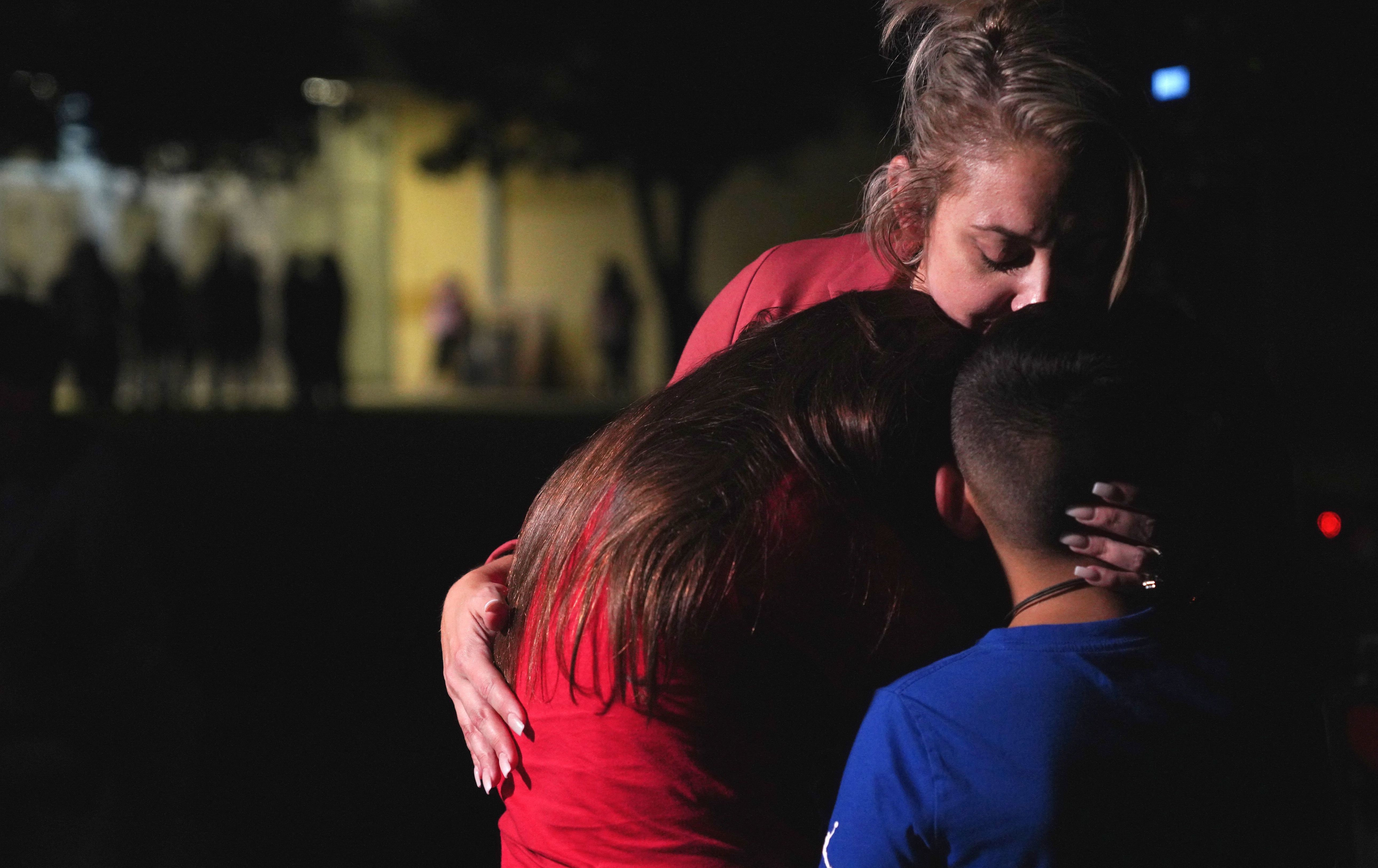 May 24: Families hug outside the Willie de Leon Civic Center where grief counseling will be offered.
