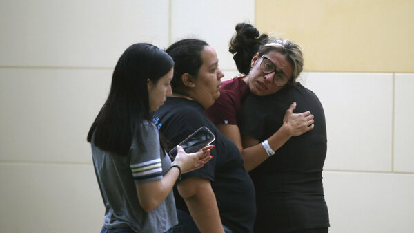 People react outside the Civic Center following a deadly school shooting at Robb Elementary School in Uvalde, Texas Tuesday, May 24, 2022.