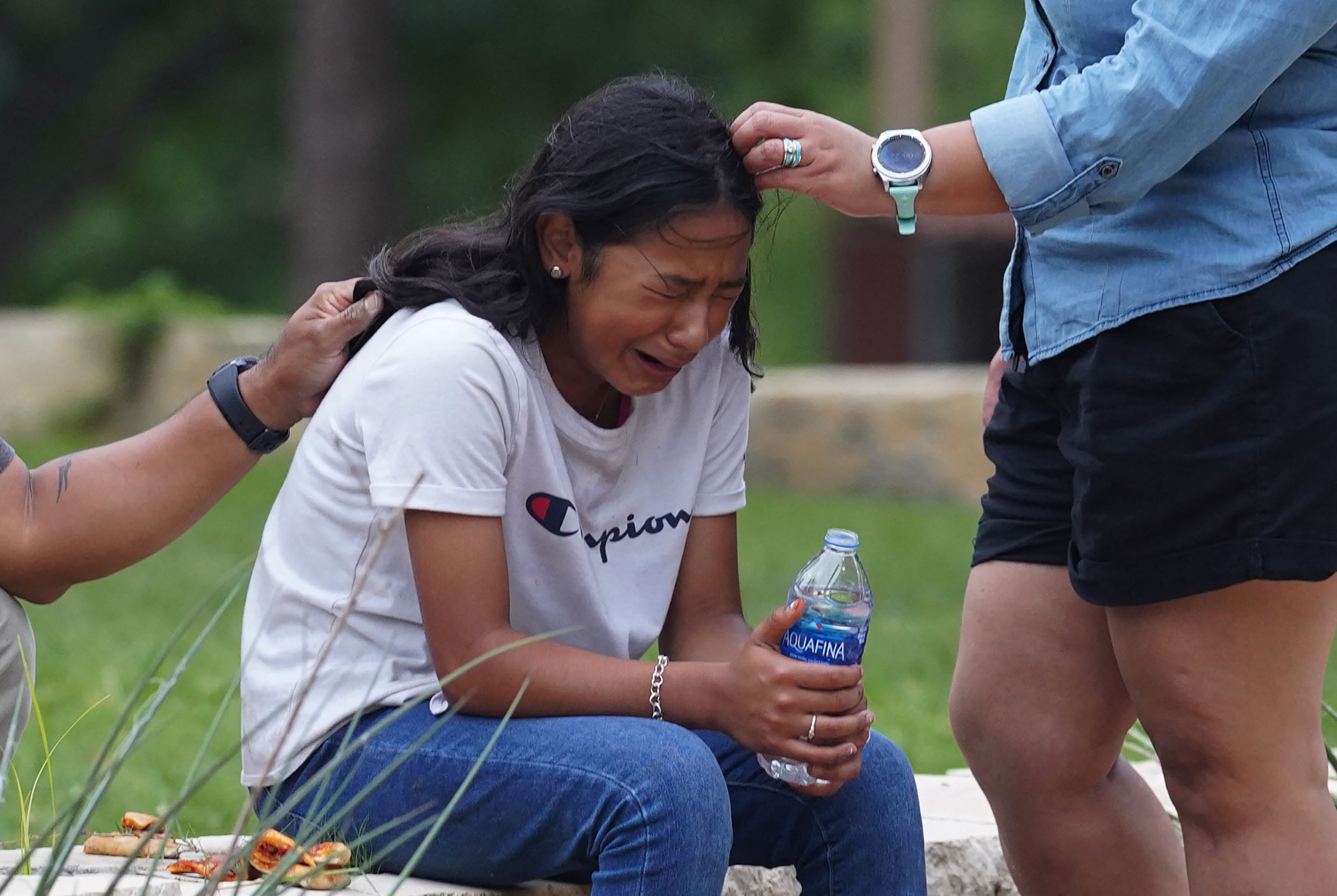 May 24: A girl cries, comforted by two adults, outside the Willie de Leon Civic Center where grief counseling will be offered.