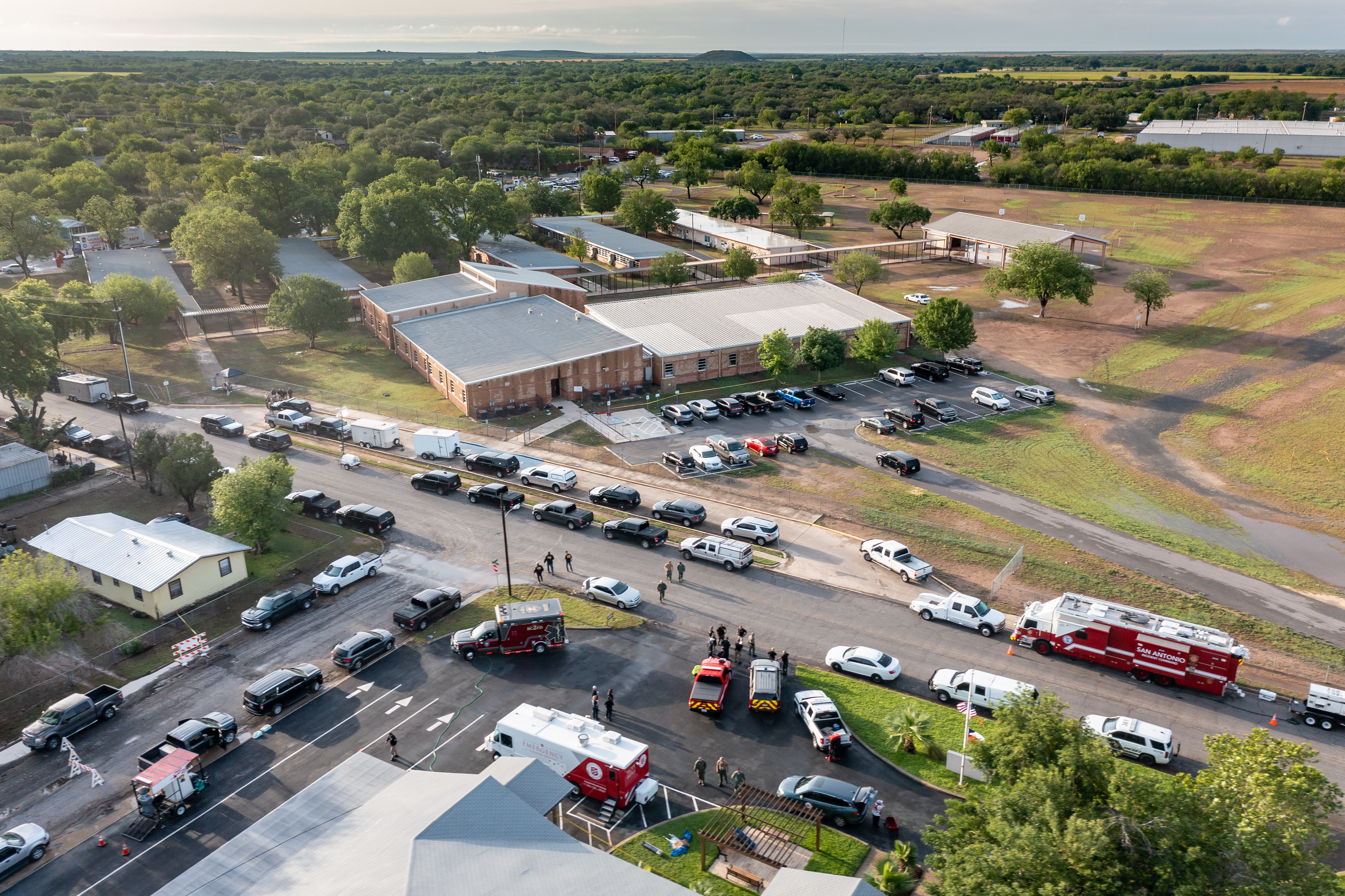 May 25: In this aerial view, law enforcement works on the scene at Uvalde, Texas' Robb Elementary School, where at least 21 people were killed Tuesday, including 19 children and two adults.