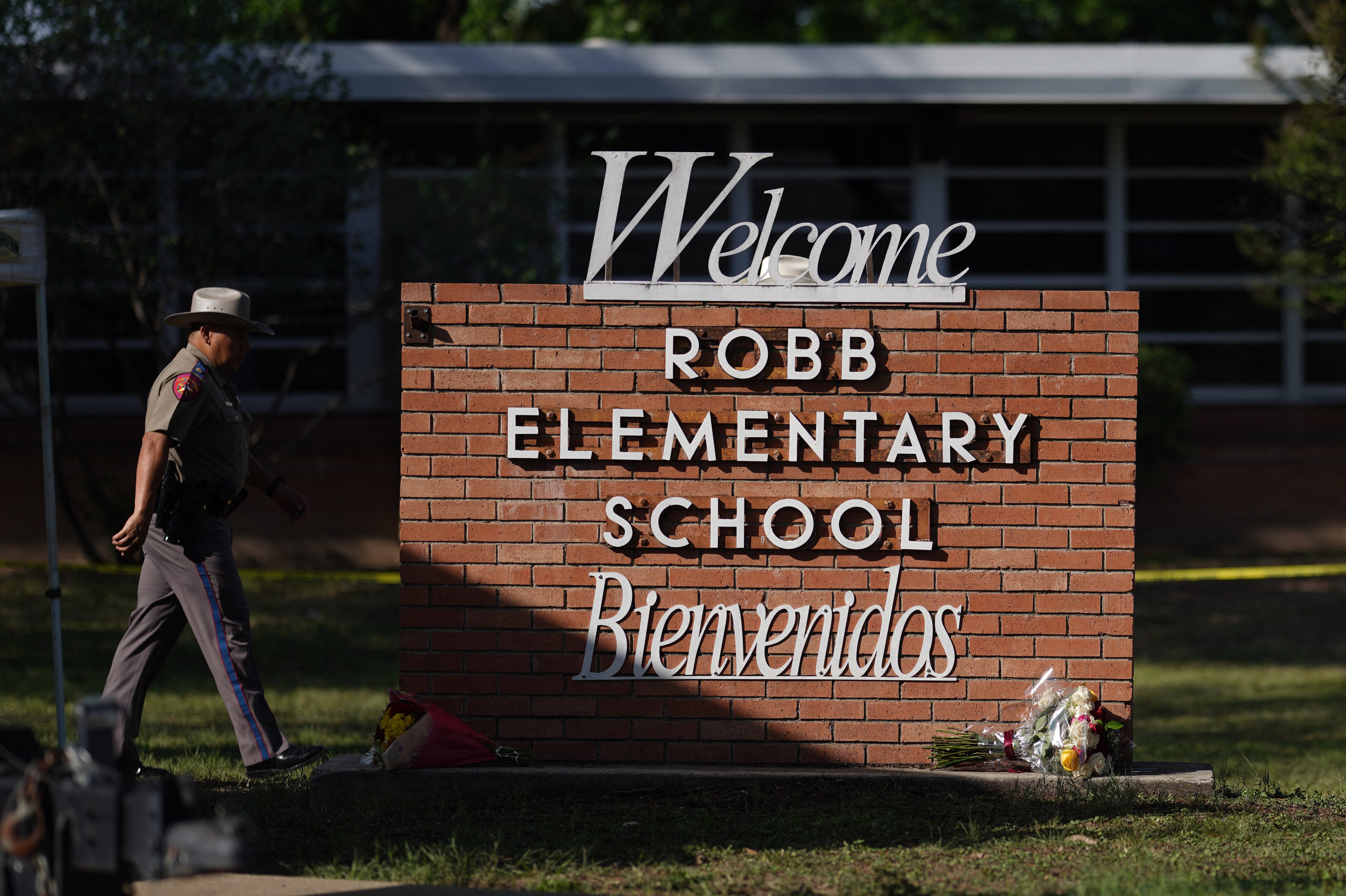 May 25: An officer walks outside of Robb Elementary School.