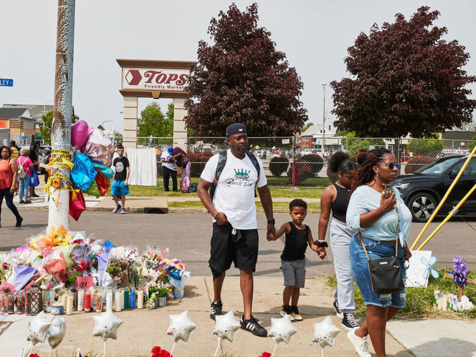 Community members gather May 21 to support each other near the Tops market that was targeted in a racist mass shooting in Buffalo, N.Y. (Mustafa Hussain/Getty Images)
