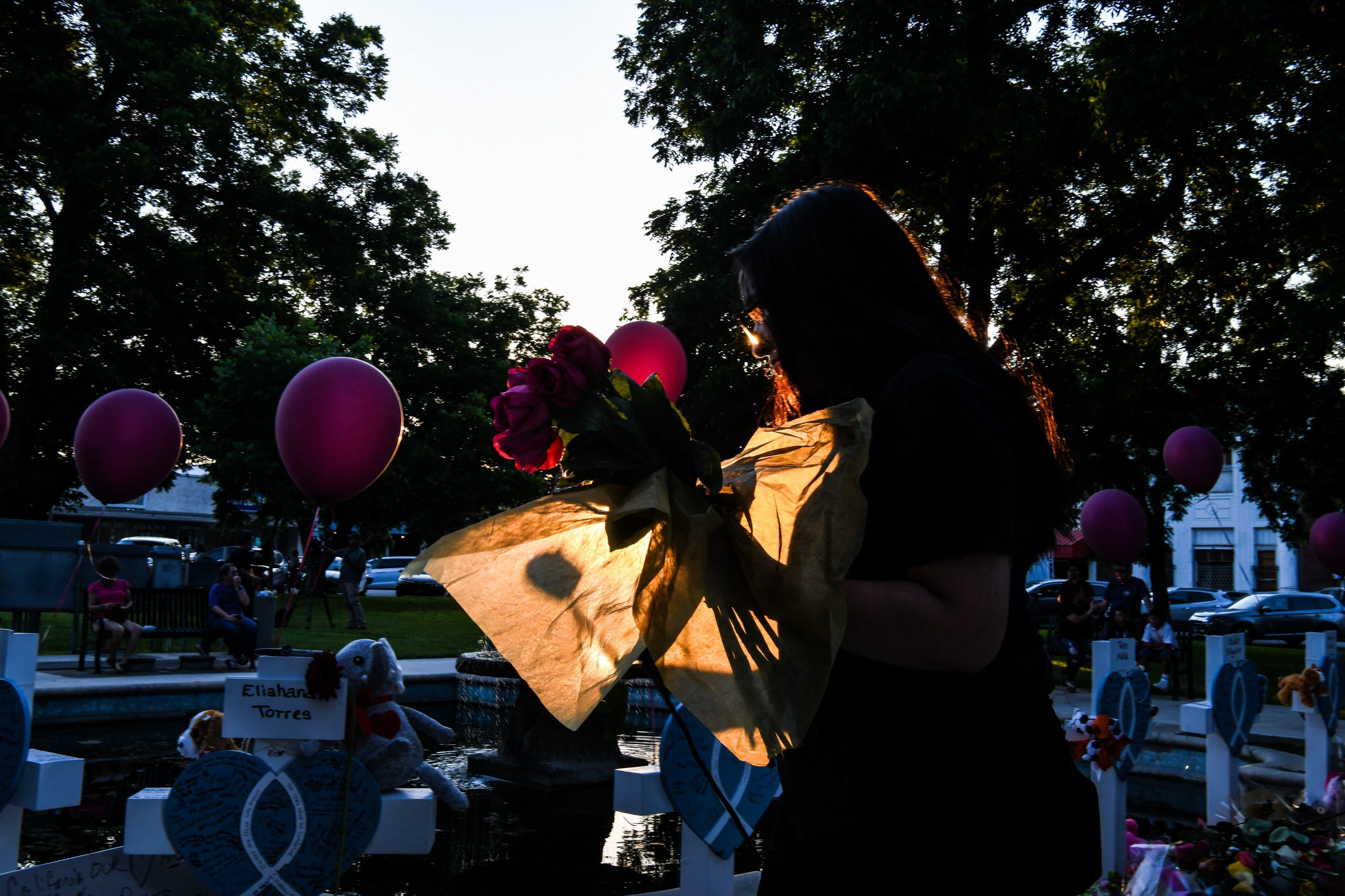 May 26: A woman brings flowers at a makeshift memorial outside Uvalde County Courthouse in Uvalde, Texas.