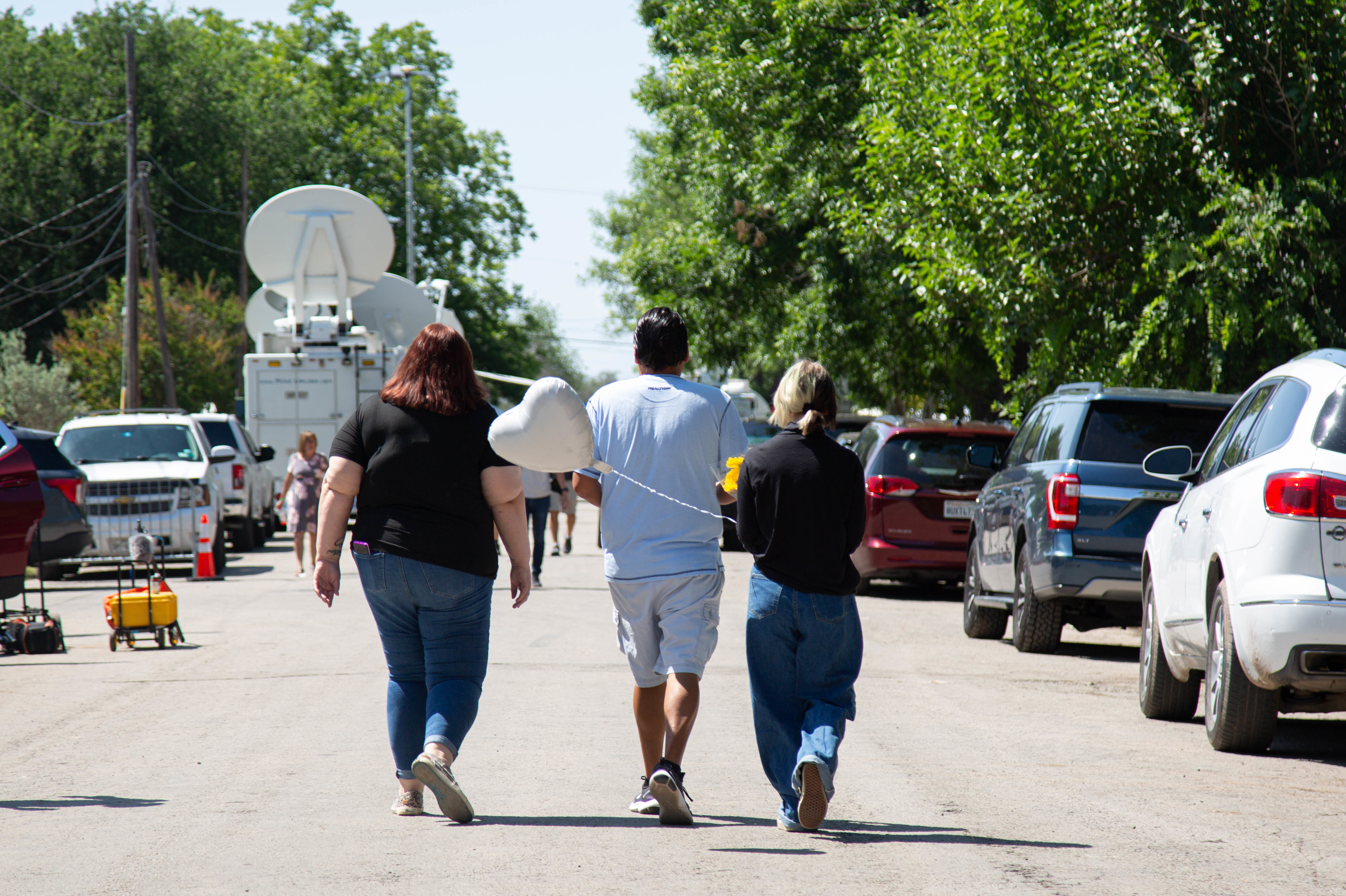 May 26: Community members walking towards the memorial at Robb Elementary School.