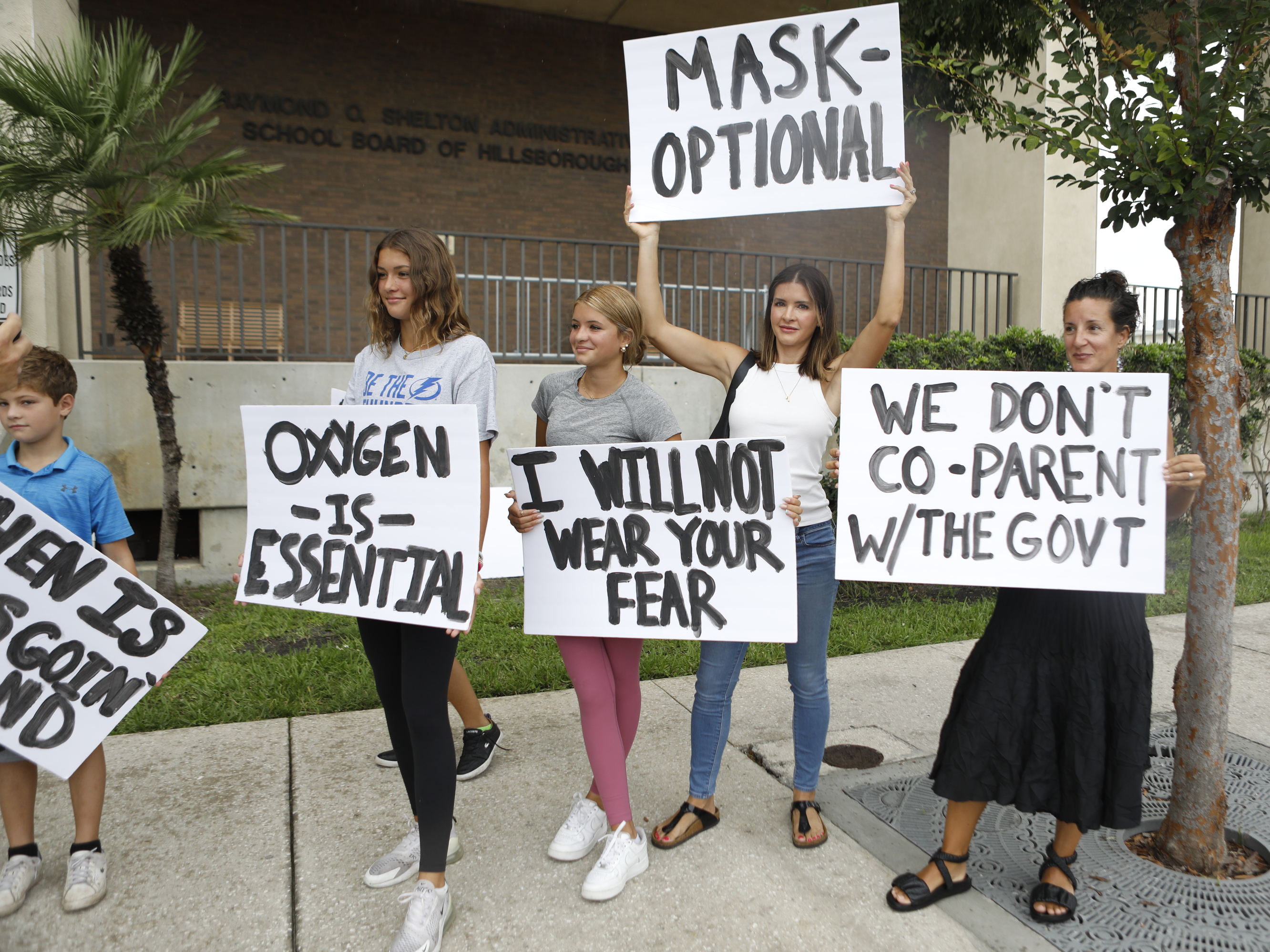 Anger over issues such as the mask mandate galvanized families — like these seen at the Hillsborough County School Board in Tampa, Fla., last year — into running for school board. Progressive groups are taking a leaf out of their playbook. (Getty Images)