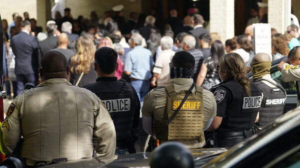 Guests arrive at the joint funeral service for Irma Garcia and her husband, Joe Garcia, at Sacred Heart Catholic Church in Uvalde, Texas, on Wednesday. Schoolteacher Irma Garcia died in the May 24 school shooting in Uvalde, and her husband died two days later of a heart attack.
