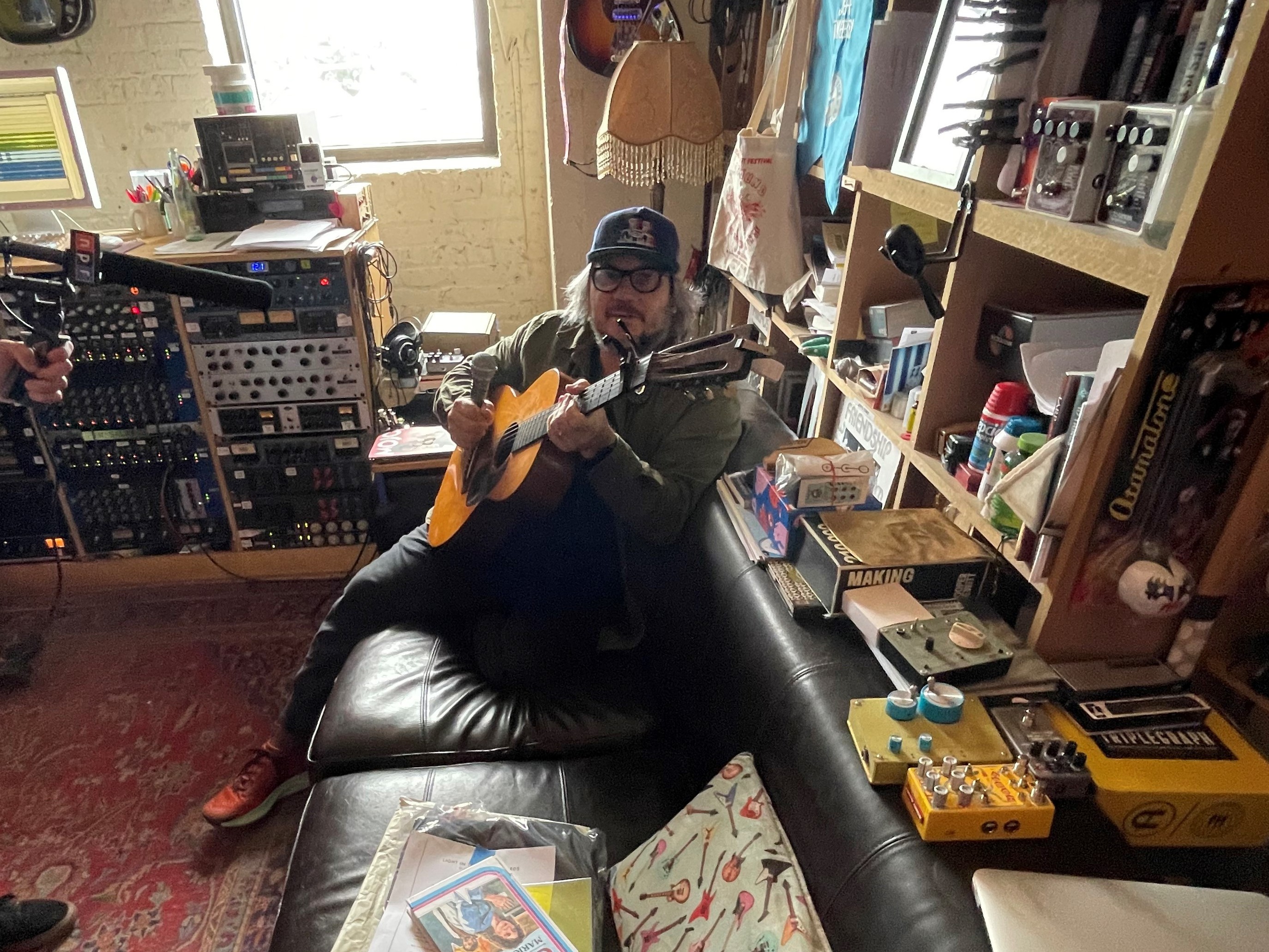 Wilco's Jeff Tweedy casually strums one of hundreds of guitars in the Wilco Loft.