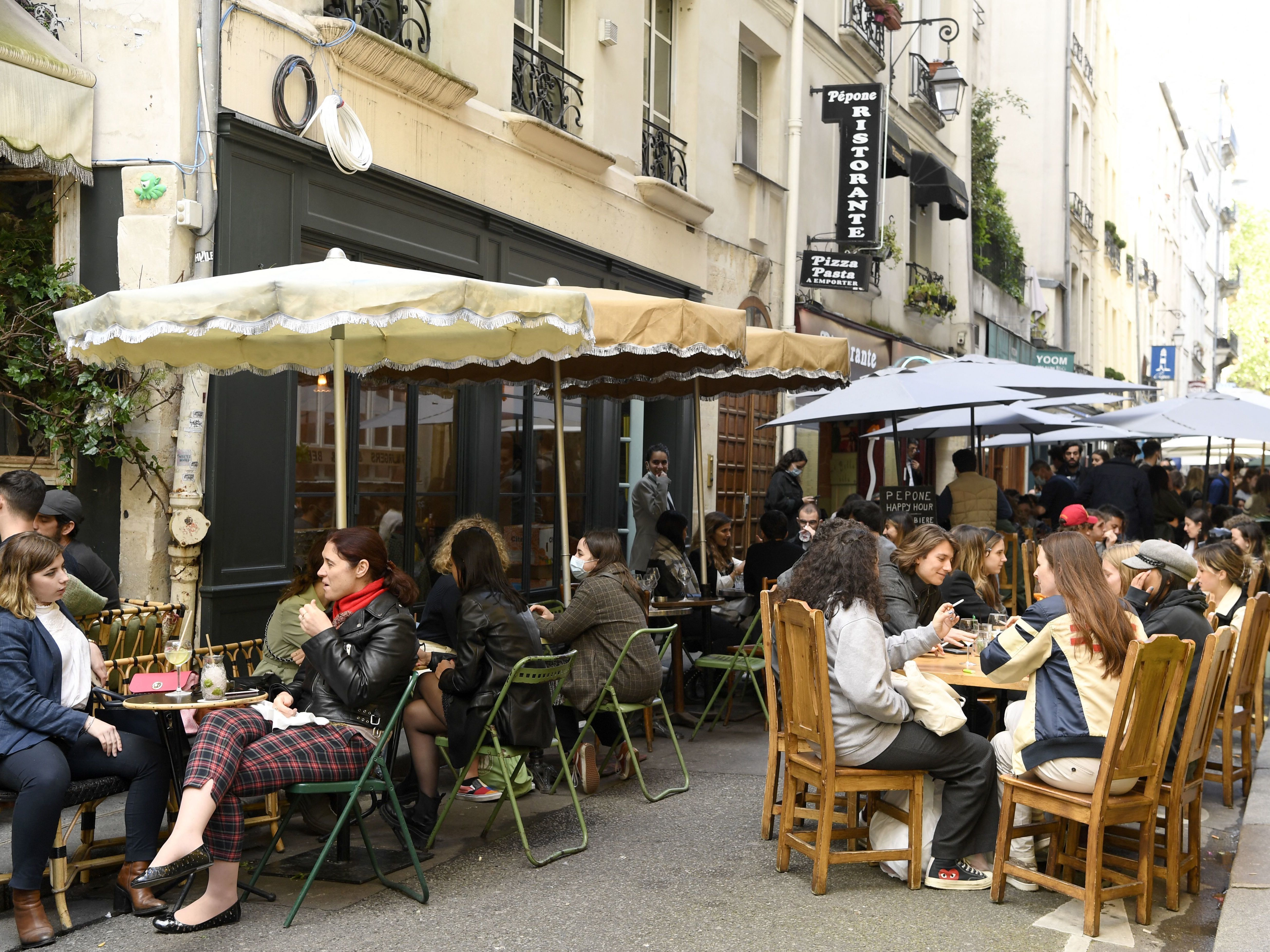 Diners sit outdoors on terraces in Paris on May 19, 2021, as cafes, restaurants and other businesses reopened as part of an easing of France's lockdown due to COVID-19.