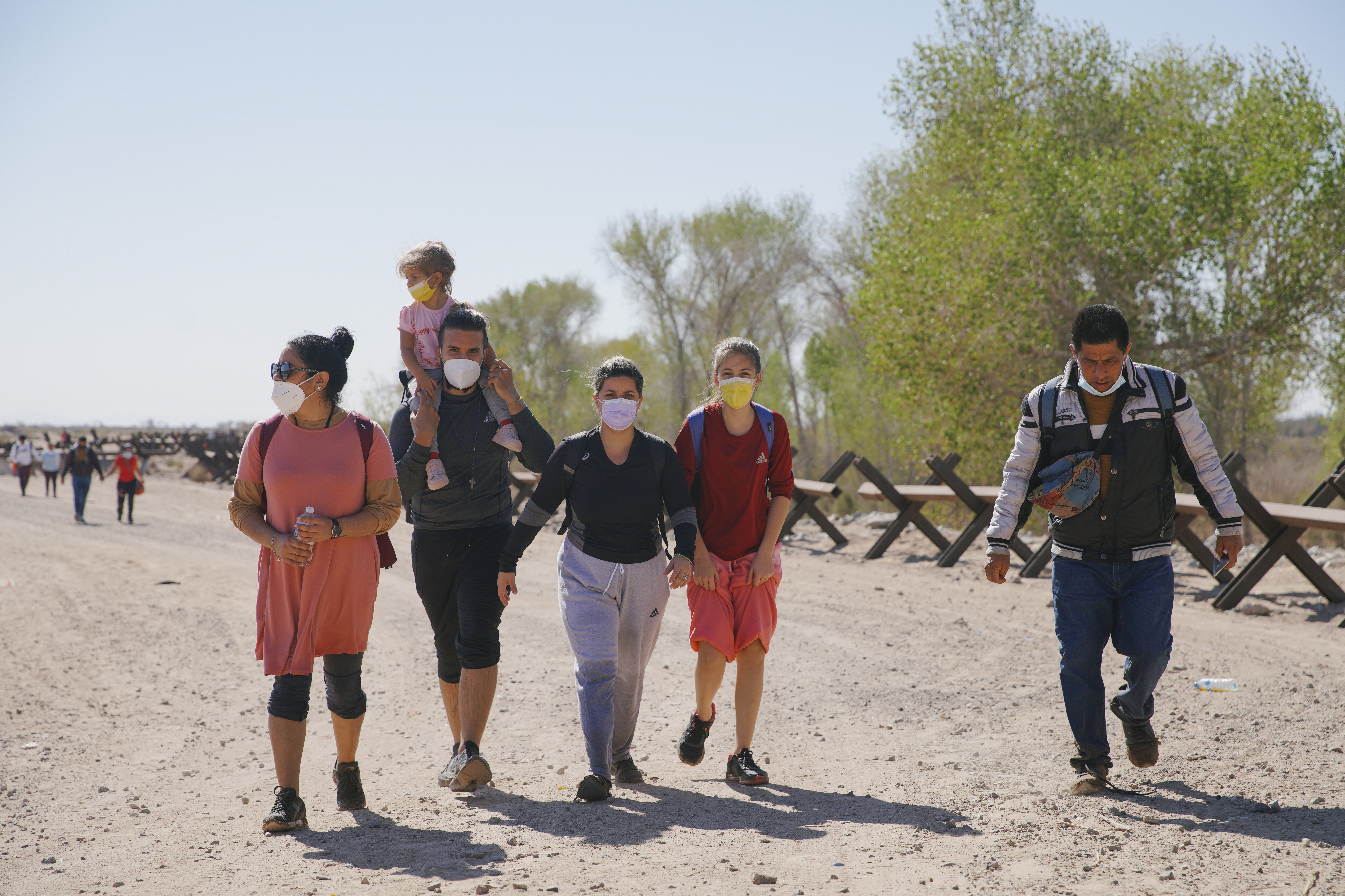 Asylum-seeking migrants from Colombia, Cuba and Venezuela arrive on U.S. soil, after crossing the Colorado River, from Mexico on Feb. 21, in Yuma, Arizona. (Anadolu Agency via Getty Images)