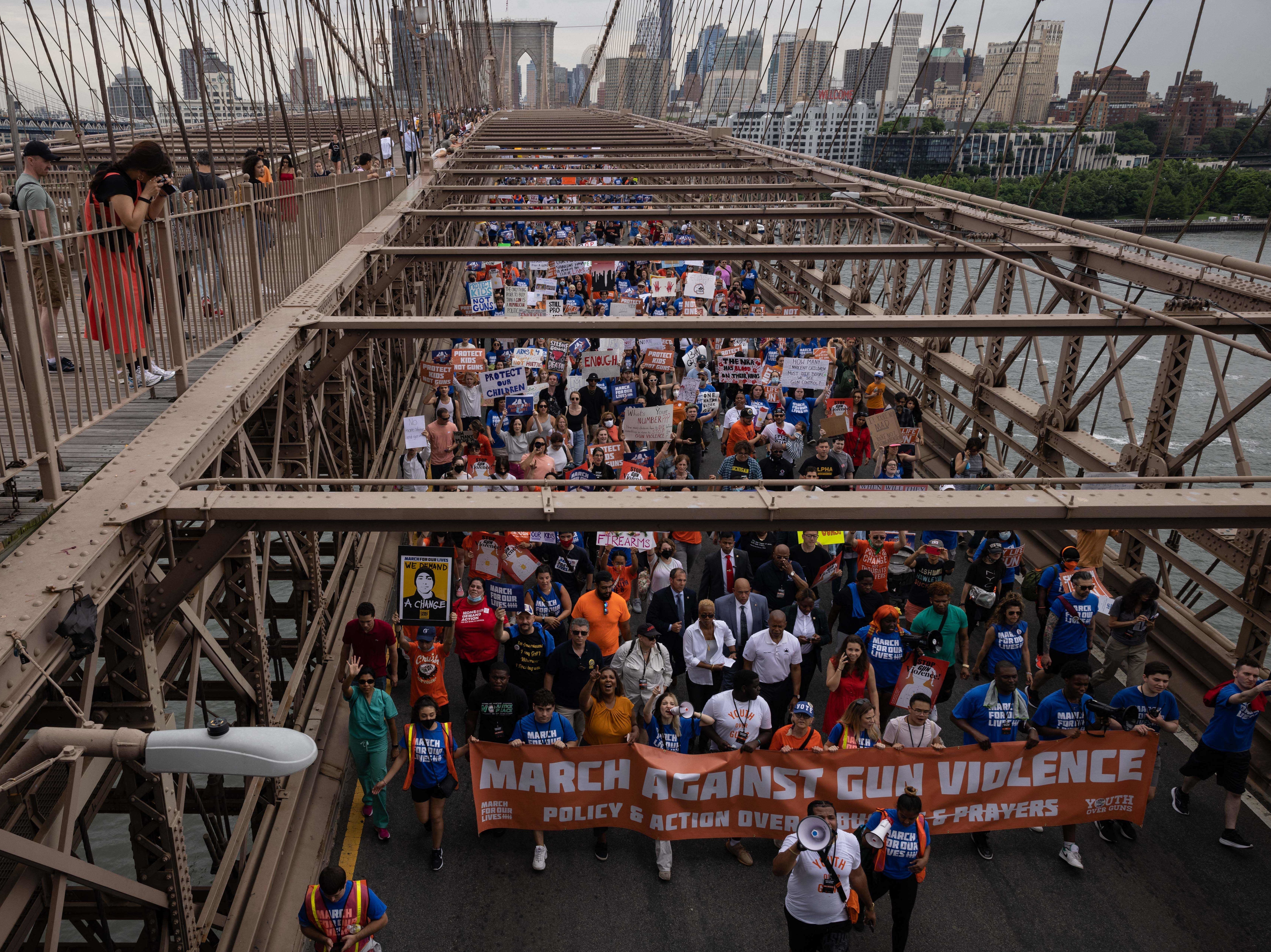 Demonstrators march across the Brooklyn Bridge during the "March for Our Lives" rally in Brooklyn, New York on Saturday.