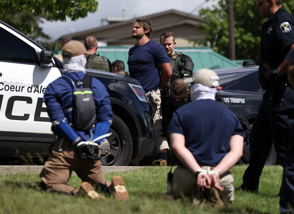 Law enforcement detains and arrest 31 members of the white nationalist group Patriot Front on suspicion of conspiracy to riot after they were removed from a U-Haul truck near the LGBTQ community's Pride in the Park event in Coeur d'Alene, Idaho, June 11, 2022. (Jim Urquhart for NPR)