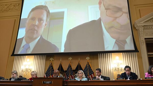 Video from an interview with former President Trump campaign manager William Stepien, left, and his attorney Kevin Marino is played during Monday