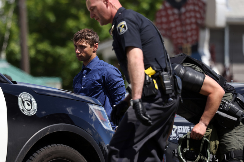 Law enforcement detains 31 members of the white nationalist group Patriot Front after they were removed from a U-Haul truck near the LGBTQ+ community's "Pride in the Park" event in Coeur d'Alene, Idaho on June 11, 2022. (Jim Urquhart/NPR)