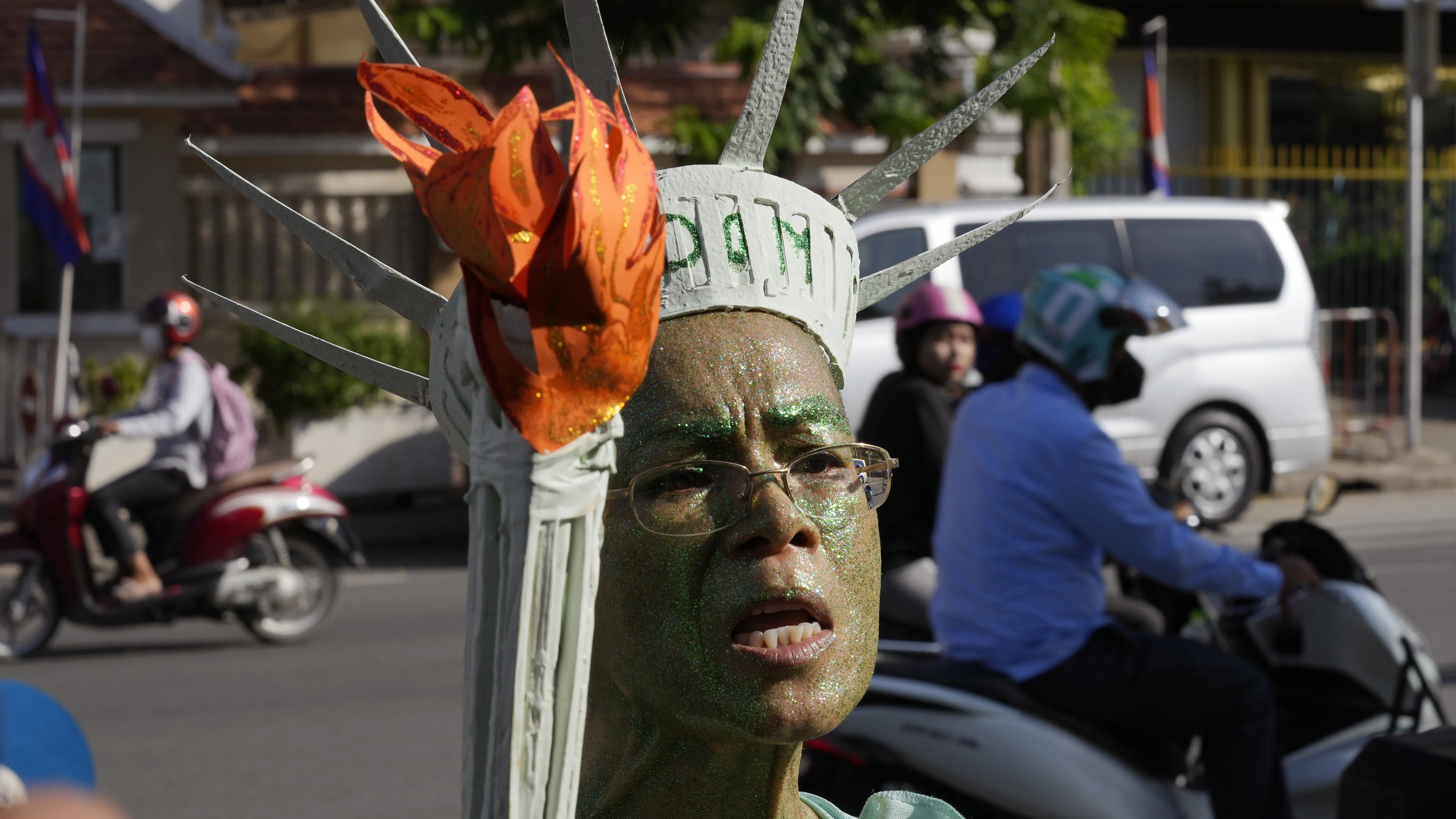 Cambodian-American lawyer Theary Seng, dressed in the Lady Liberty talks to the media outside Phnom Penh Municipal Court in Phnom Penh, Cambodia, Tuesday, June 14, 2022.