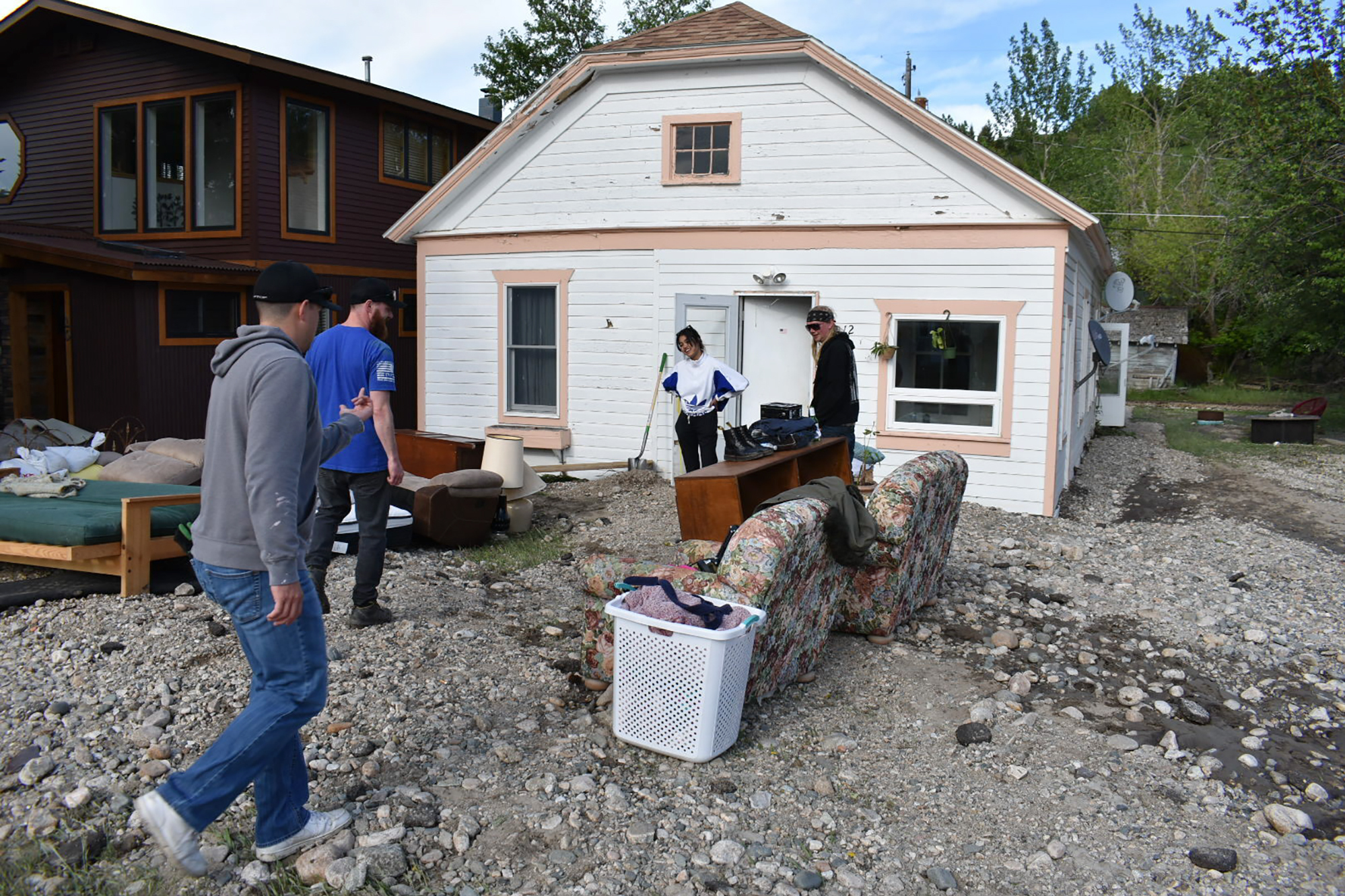 Residents of Red Lodge, Mont., inspect damage to a house that was flooded after torrential rains fell across the Yellowstone region, on Tuesday.