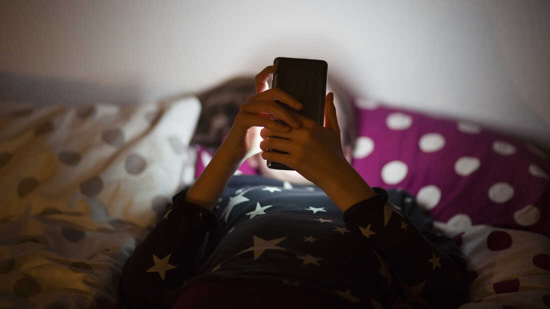 A child uses a cell phone.