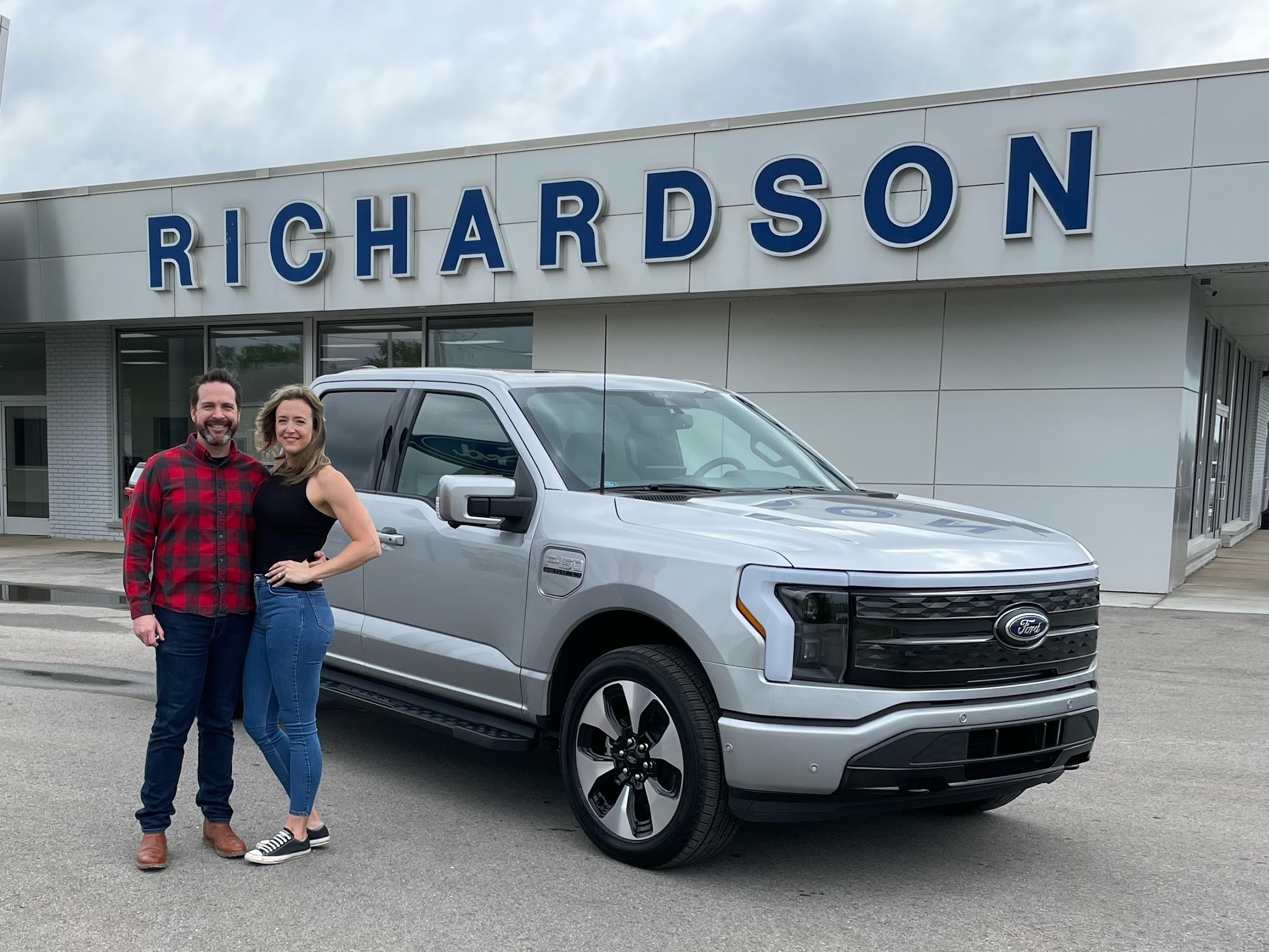 Nick Schmidt poses with his wife after picking up his brand new electric F-150. Schmidt was the first buyer to get the F-150 Lightning as auto makers are betting billions in an electric future. (Courtesy of Nick Schmidt)
